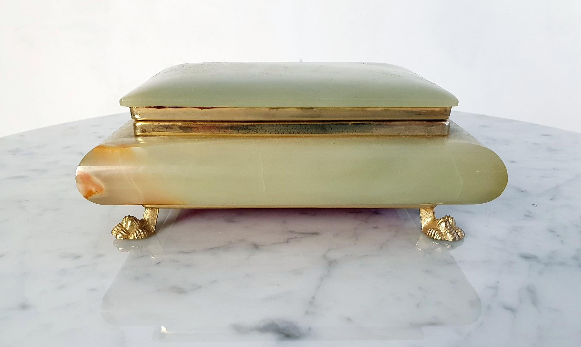 Elevate your treasures with a stunning handmade onyx trinket box. Crafted with meticulous care, this sizable box features a hinged lid and exquisite gilded lion's feet for a touch of opulence. Embrace the perfect blend of beauty and functionality in