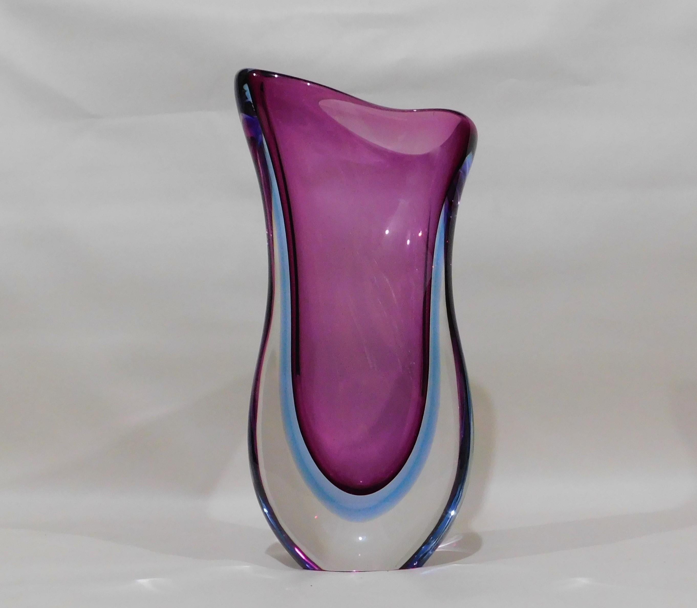 Large and beautiful midcentury Murano Italy hand blown purple/violet and blue toned encased in a thick clear glass overlay art glass flower vase. Attributed to designer Archimede Seguso, circa 1960. Measure: 14 inches high.