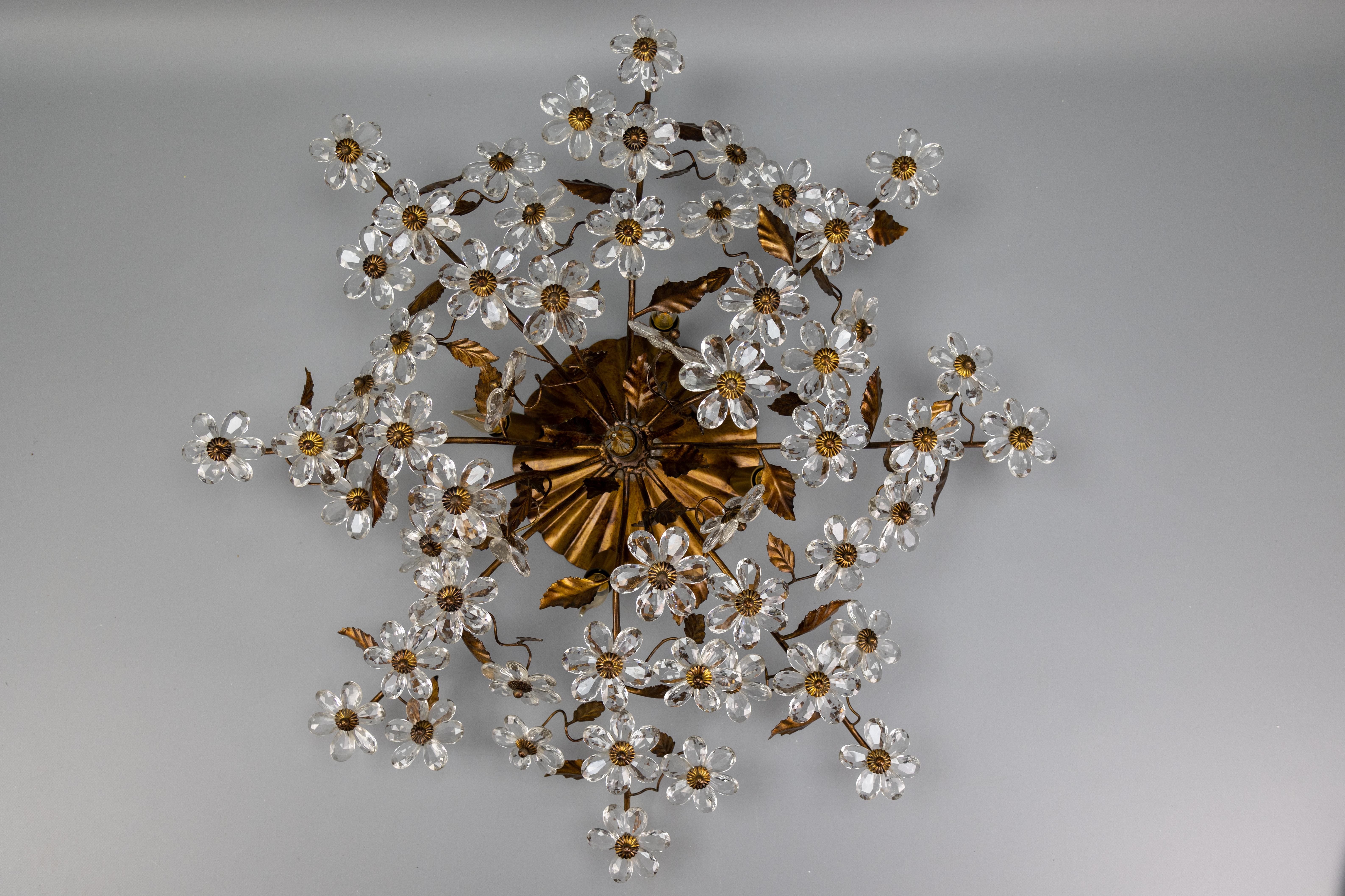 Large Hollywood Regency style crystal glass, floral, and gold metal five-light ceiling lamp.

A strikingly ornate ceiling light in the Hollywood Regency style, crafted in Italy during the 1950s. This large-scale fixture features an elaborate bouquet