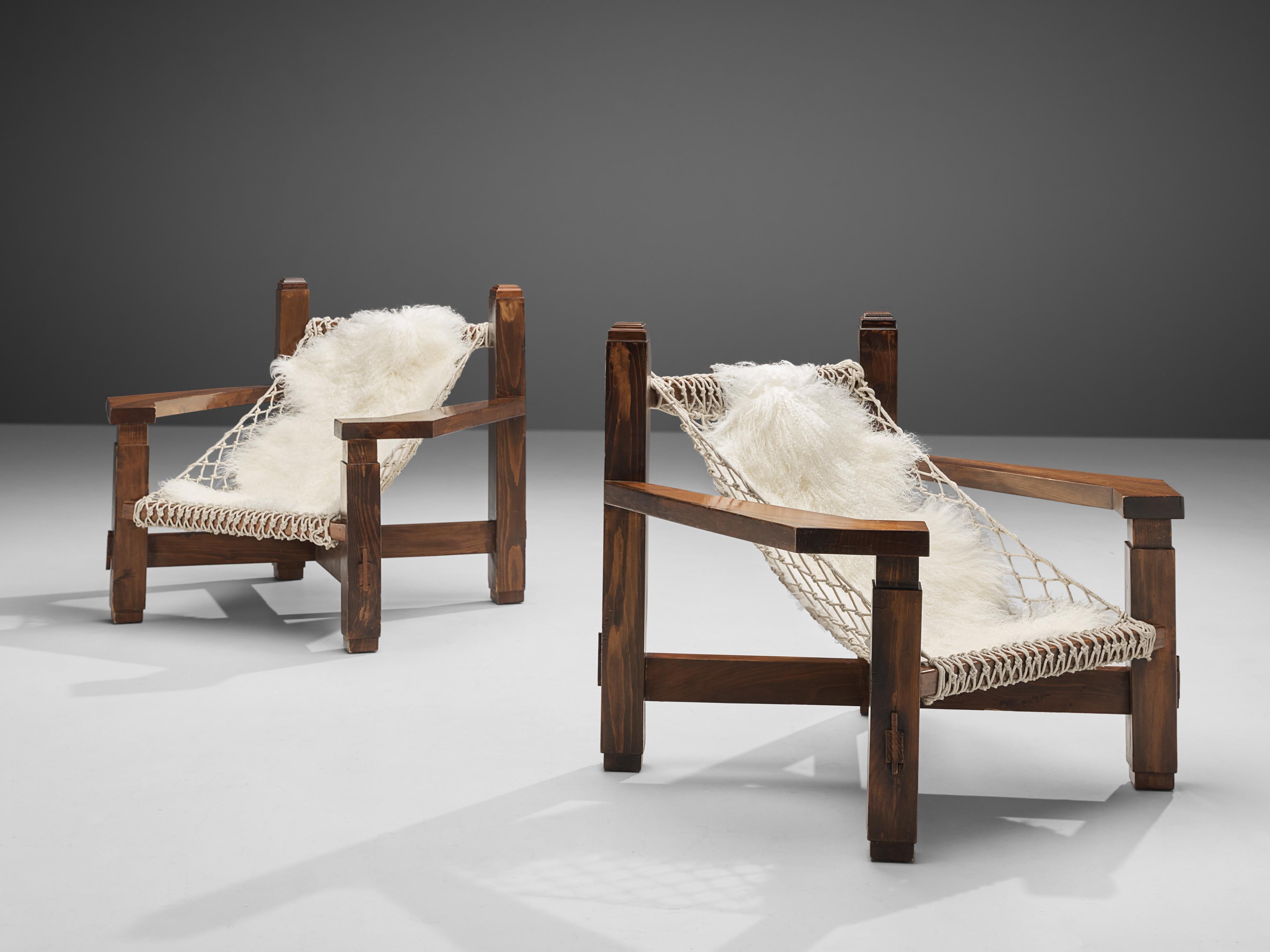 Lounge chairs, stained pine, rope, Italy, 1970s

The designer of this Italian lounge chair truly wanted to impress the viewer with a monumental, volumetric design. The wide frame in stained pine features wonderful lines. Par example, the decorative