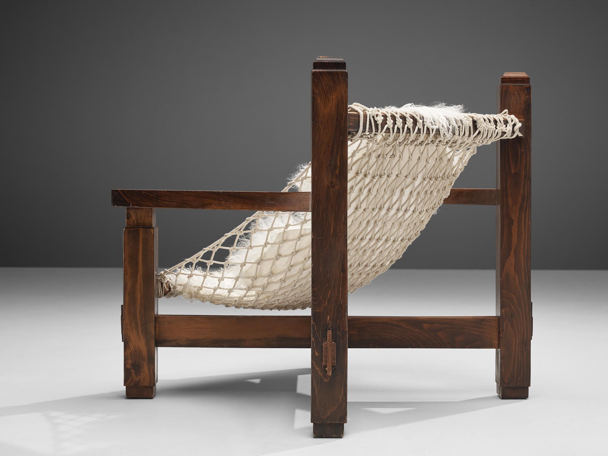 Lounge chair, stained pine, rope, Italy, 1970s

The designer of this Italian lounge chair truly wanted to impress the viewer with a monumental, volumetric design. The wide frame in stained pine features wonderful lines. Par example, the decorative