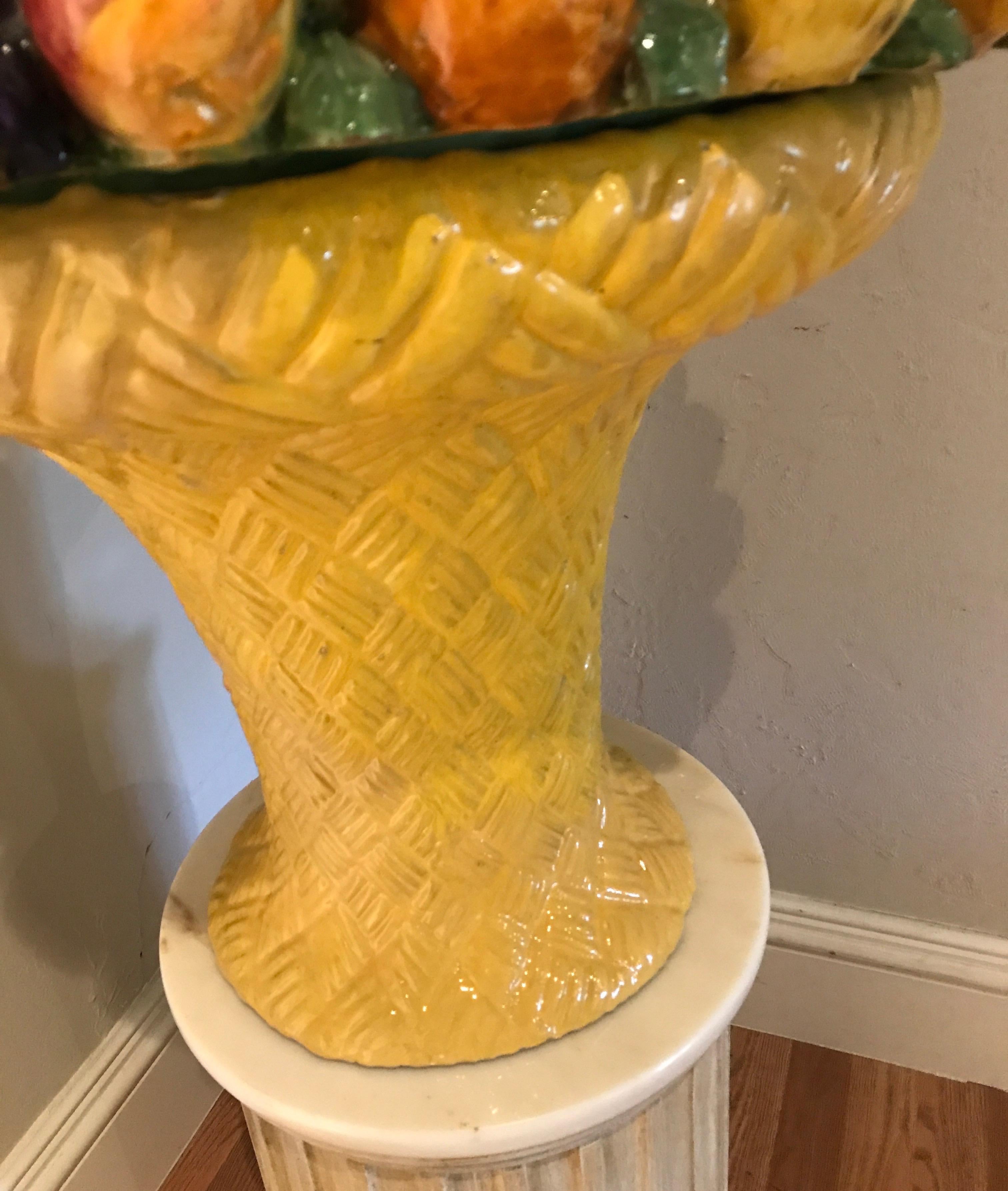 A unique and striking Italian Majolica fruit basket in two parts. Basket weave base with multicolored top featuring a cornucopia of fruits.