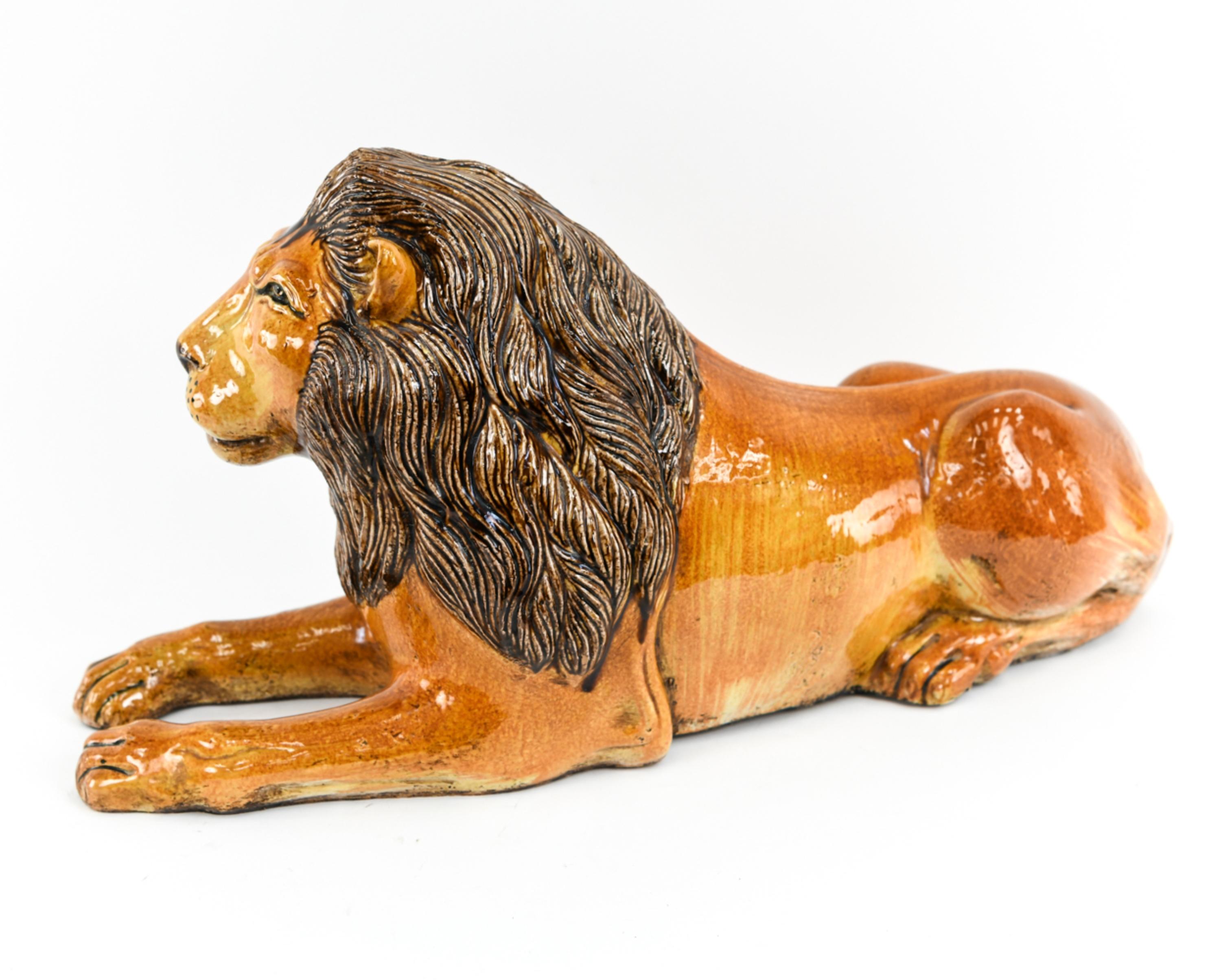 This majestic clay lion sculpture makes a decorative statement as a console centerpiece or doorway sentry. Apparently unsigned.