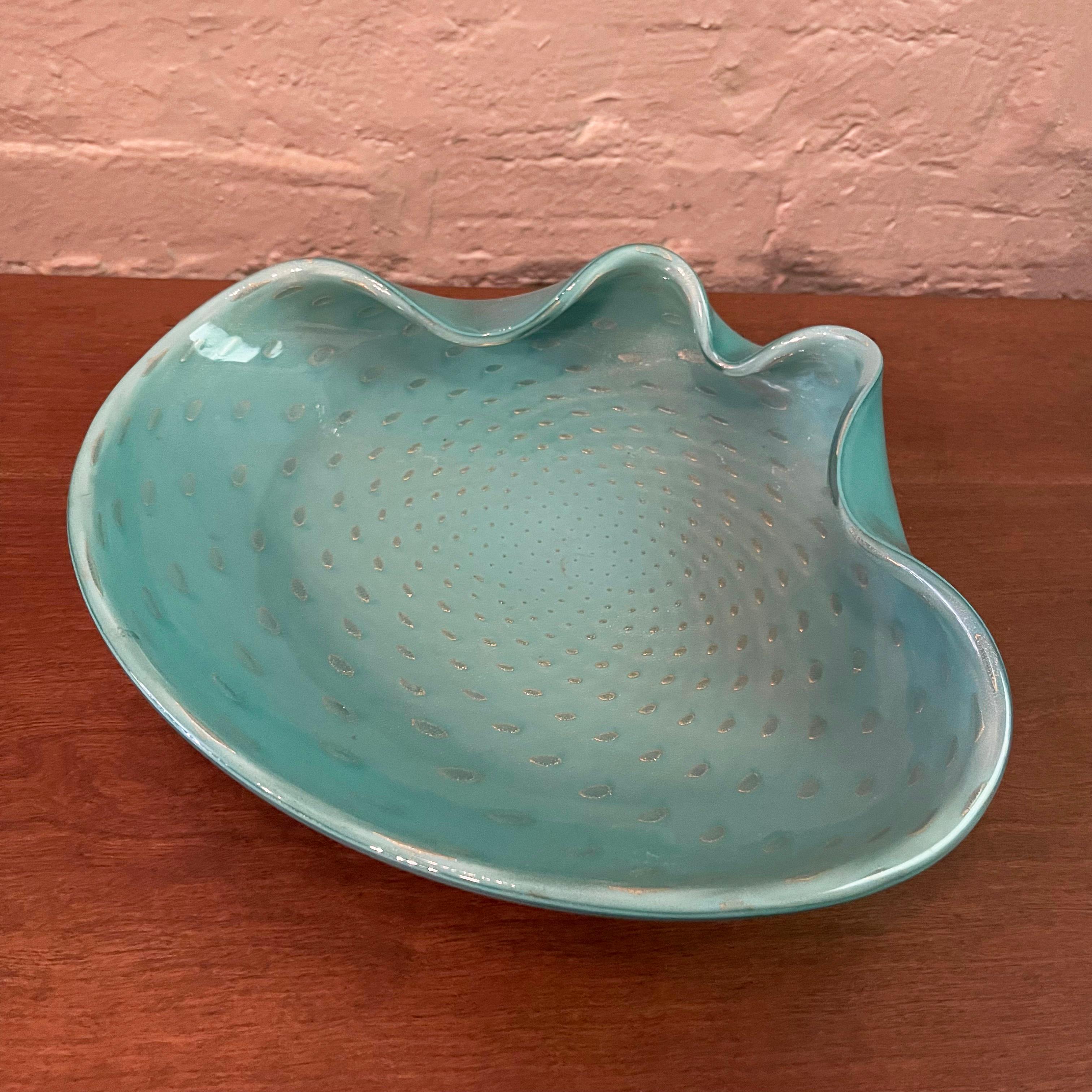 Large, Italian, mid-century, pale blue opaque, Murano glass dish in a clamshell shape features a raised bullicante interior accented with flecks of gold. 