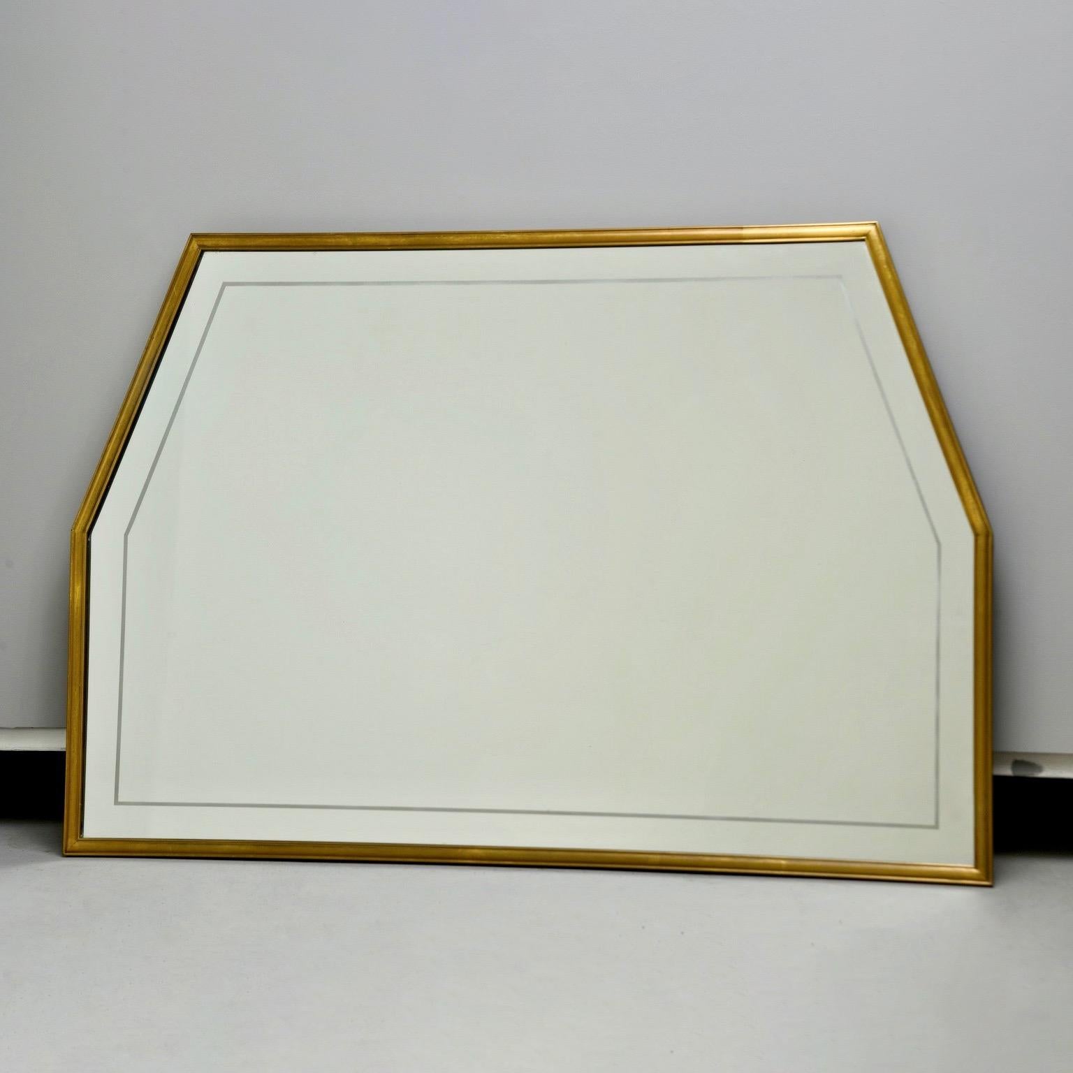 Circa 1960s Italian mirror has a narrow brass frame and six sided trapezoidal shape. Mirror itself has an etched border. Unknown maker.


Actual Mirror Size:  33.5” h x 50” w