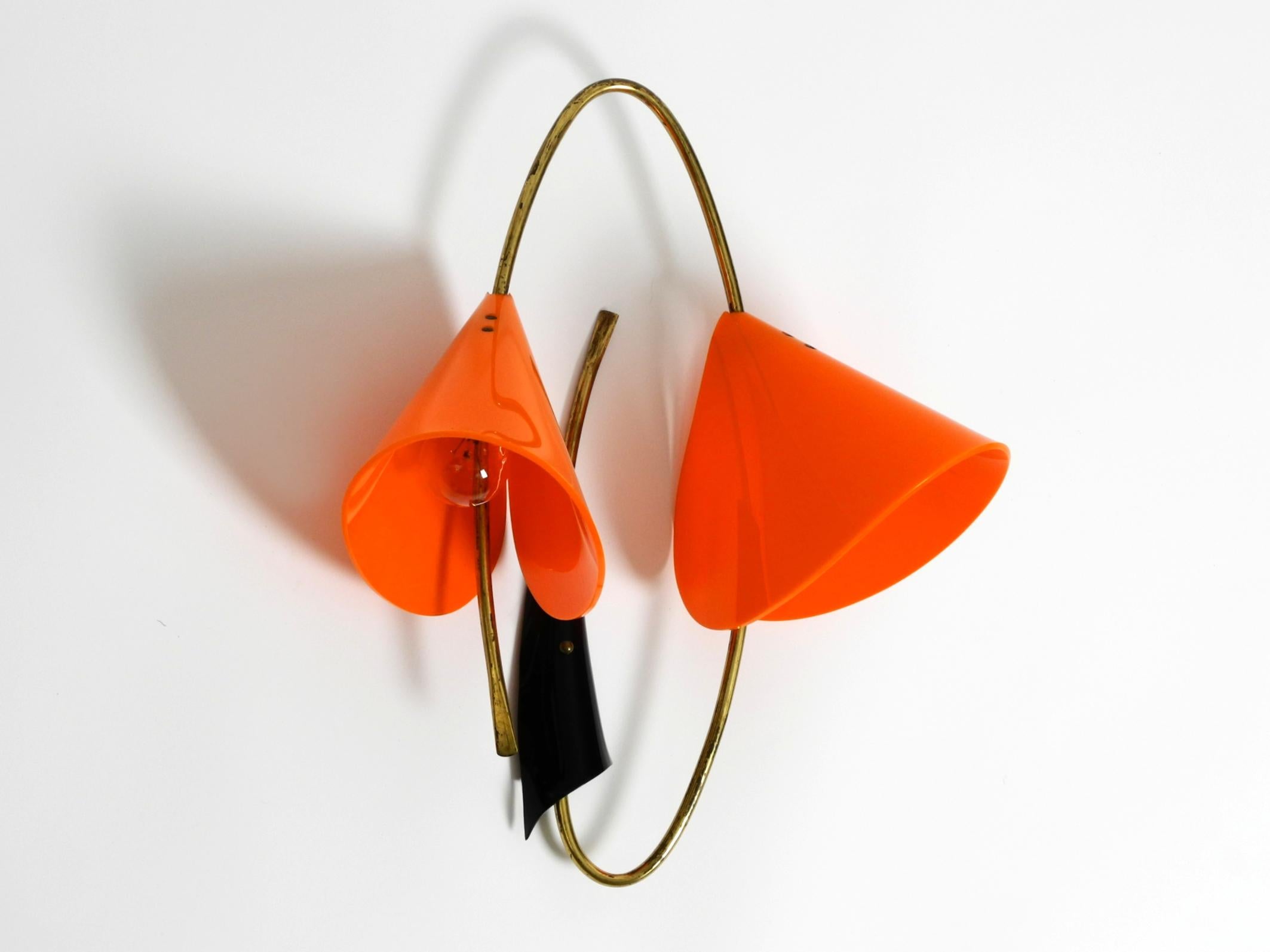 Beautiful large Italian Mid Century Modern brass wall lamp.
Typical Mid Century design in very nice original condition.
Frame is made of brass tube and metal plate. Shades are made of orange acrylic glass.
Has already been rewired. Nothing needs to