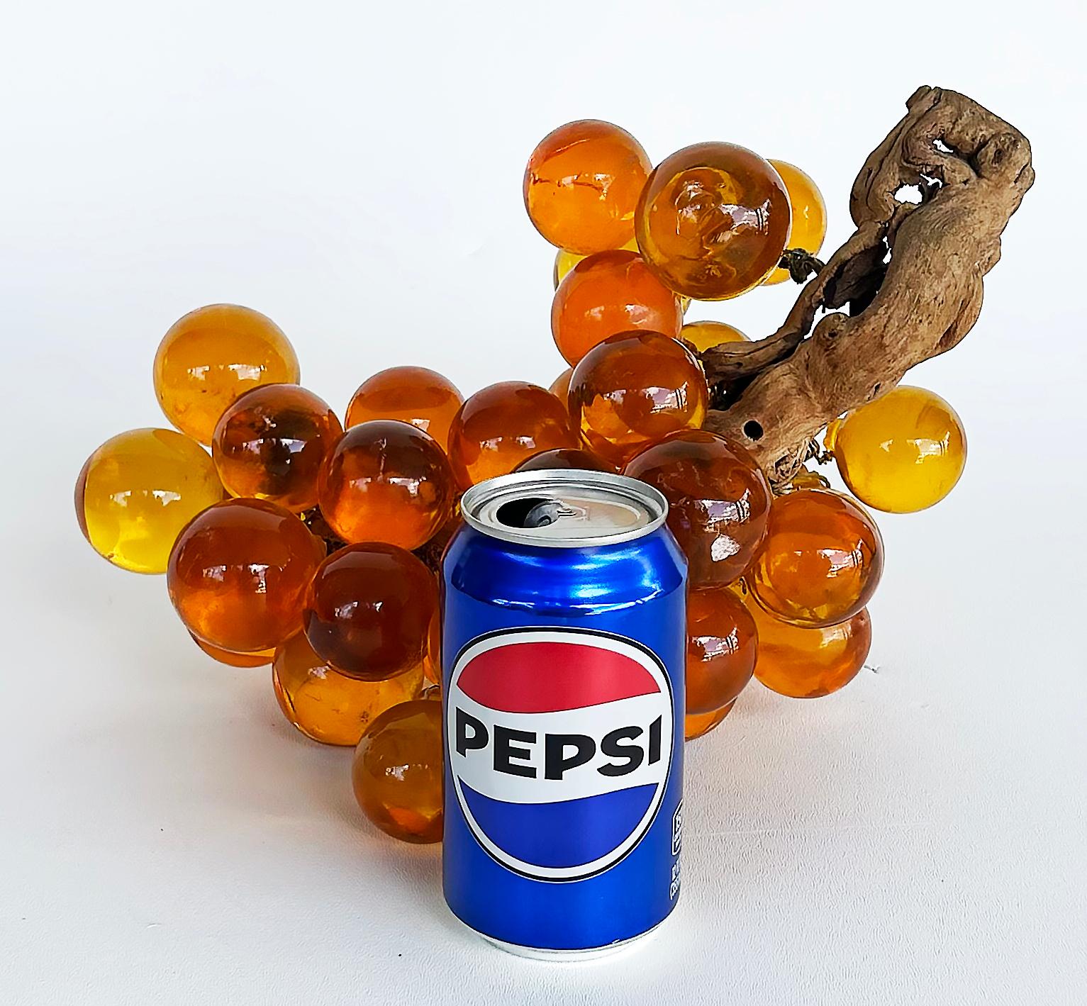 Large Mid-century Modern Amber Lucite Grapes, Olive Branch Stem

Offered for sale is a large mid-century modern amber acrylic Lucite and olive branch cluster of grapes. The cluster is striking with an iconic look.