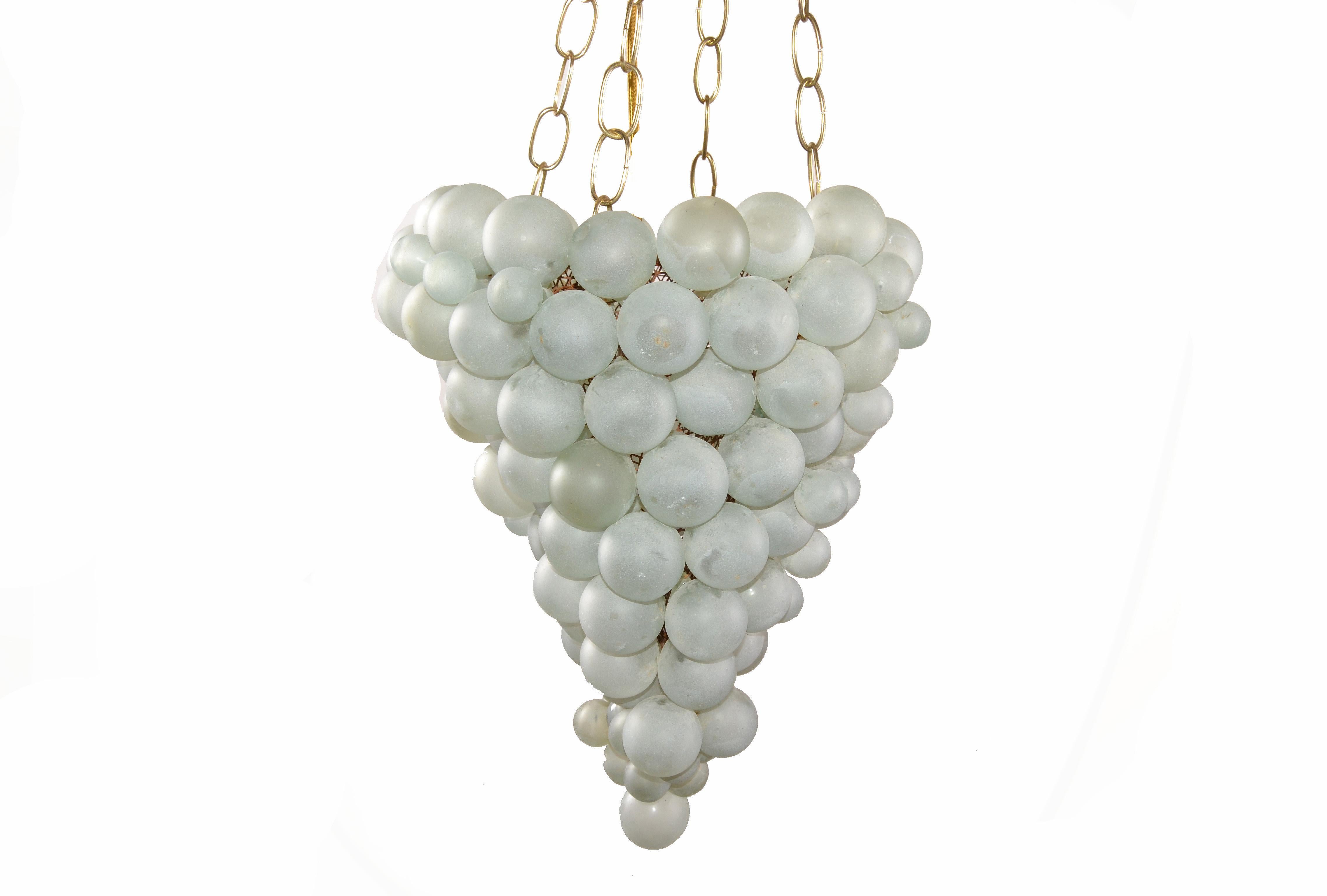 Large Italian Mid-Century Modern blown Murano glass balls in grape shape chandelier.
The different glass balls are mounted onto a wire basket and is hanging on 4 brass chains.
Takes one light bulb with max. 100 watts.
Great piece for Your Home