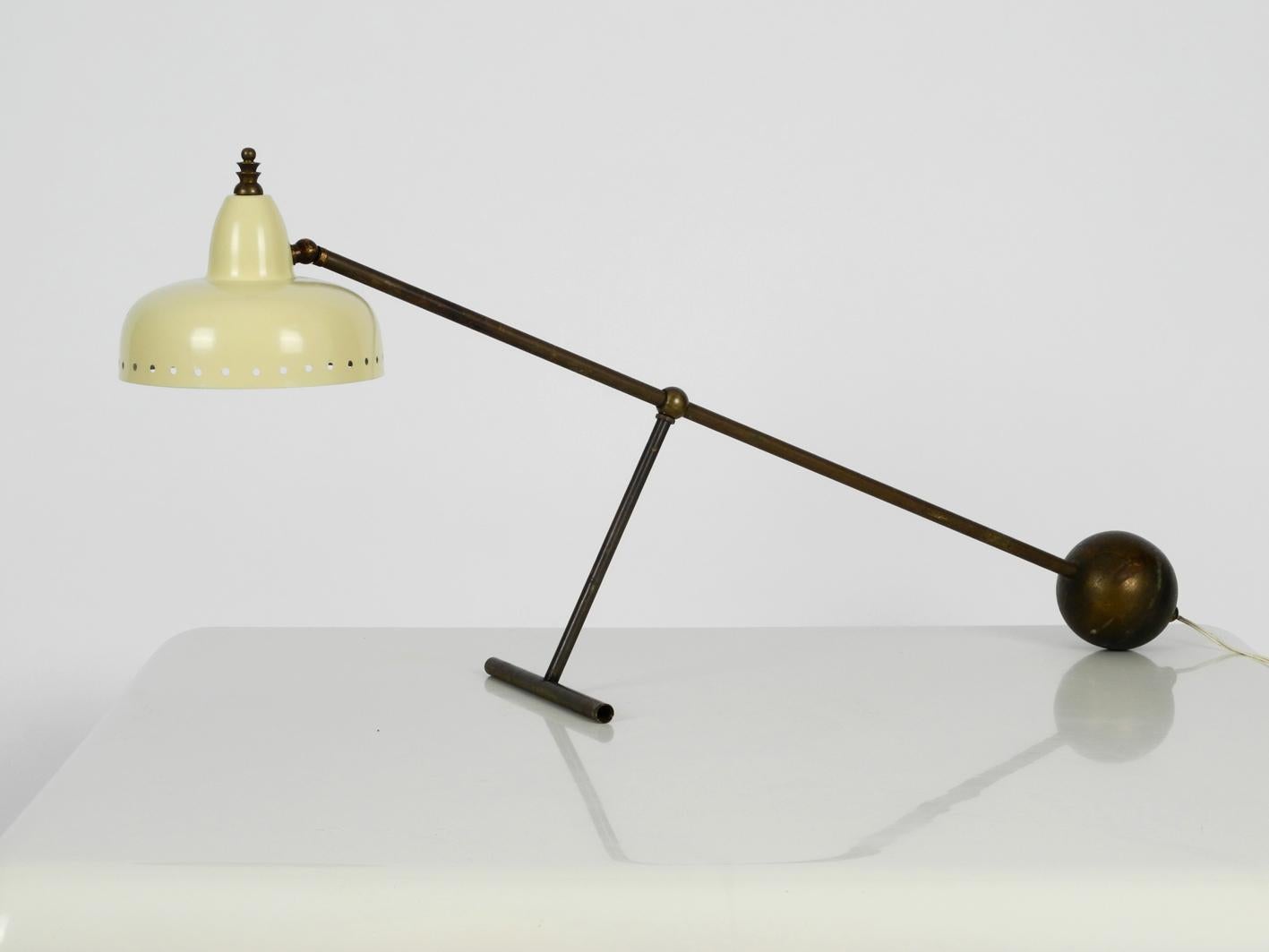 Large Italian Mid-Century Modern Industrial height adjustable table lamp. Frame made of brass pipe inside the cable. Very beautiful elaborate lampshade in light yellow aluminium. Very nice striking mid-century design with fantastic patina. Very good