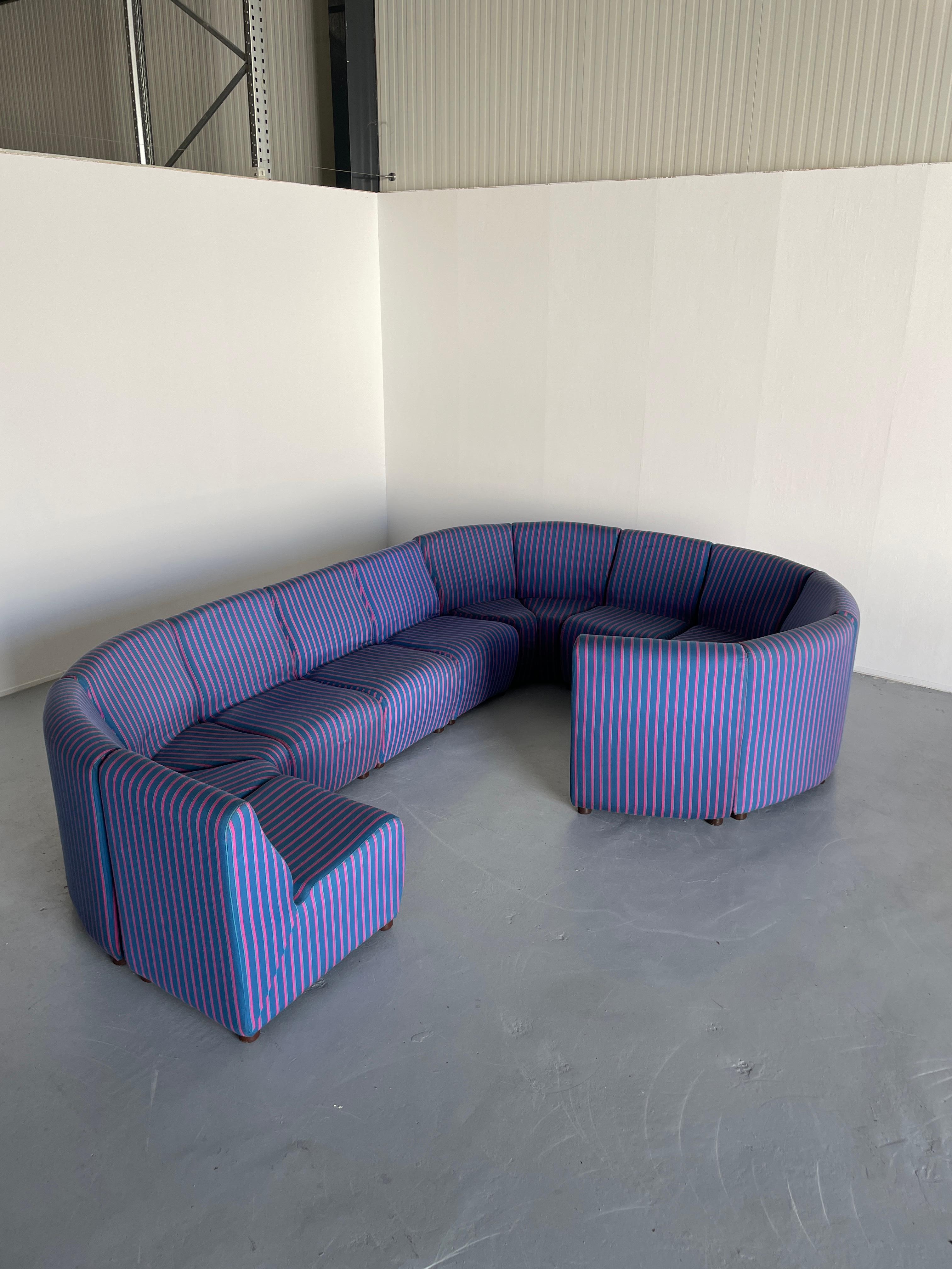 A stunning thirteen-piece Mid-Century-Modern modular serpentine sofa in blue striped upholstery. 

Made from moulded foam and a metal construction. Lightweight.

In very good vintage condition with expected signs of age. 
No tears on the fabric. No