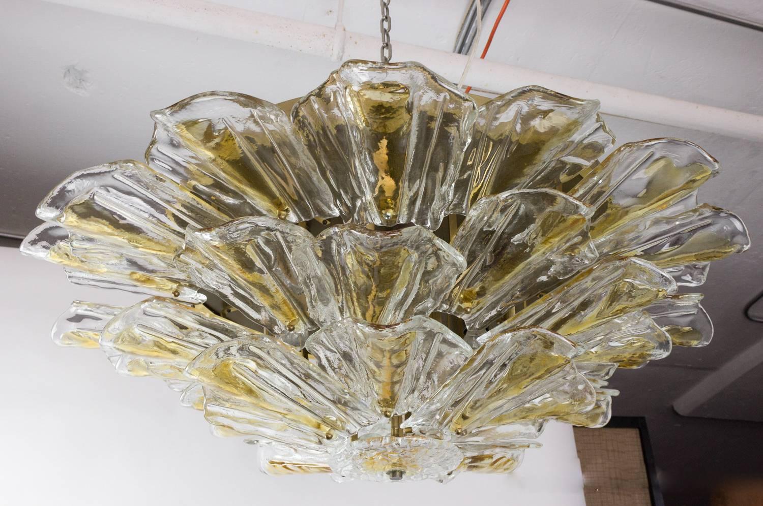 Large flush mounted Murano ceiling fixture with three tiers of dual tone glass; Italian, 1960s. This fixture has been UL wired and tested and fits 12 candelabra bulbs arranged in two concentric rings. The polished brass backplate has also be