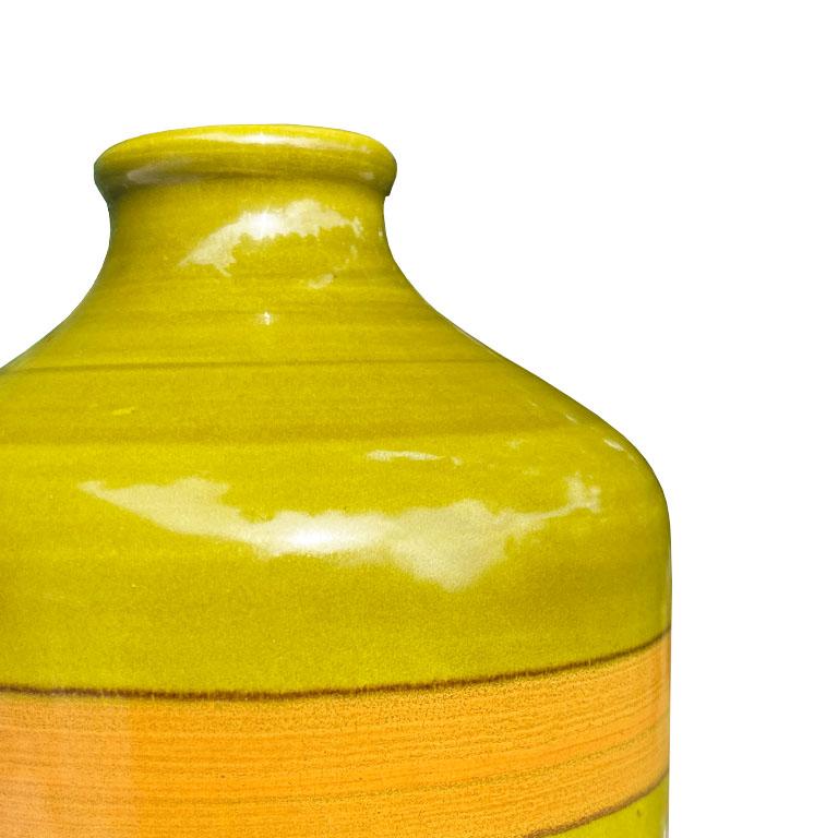 A striking olive green ceramic vase for Raymor. This piece is large and an excellent example of Italian craftsmanship. The piece resembles a jug and has a wide body, with a narrowed rim at the top. The entire piece is glazed in an olive green, with