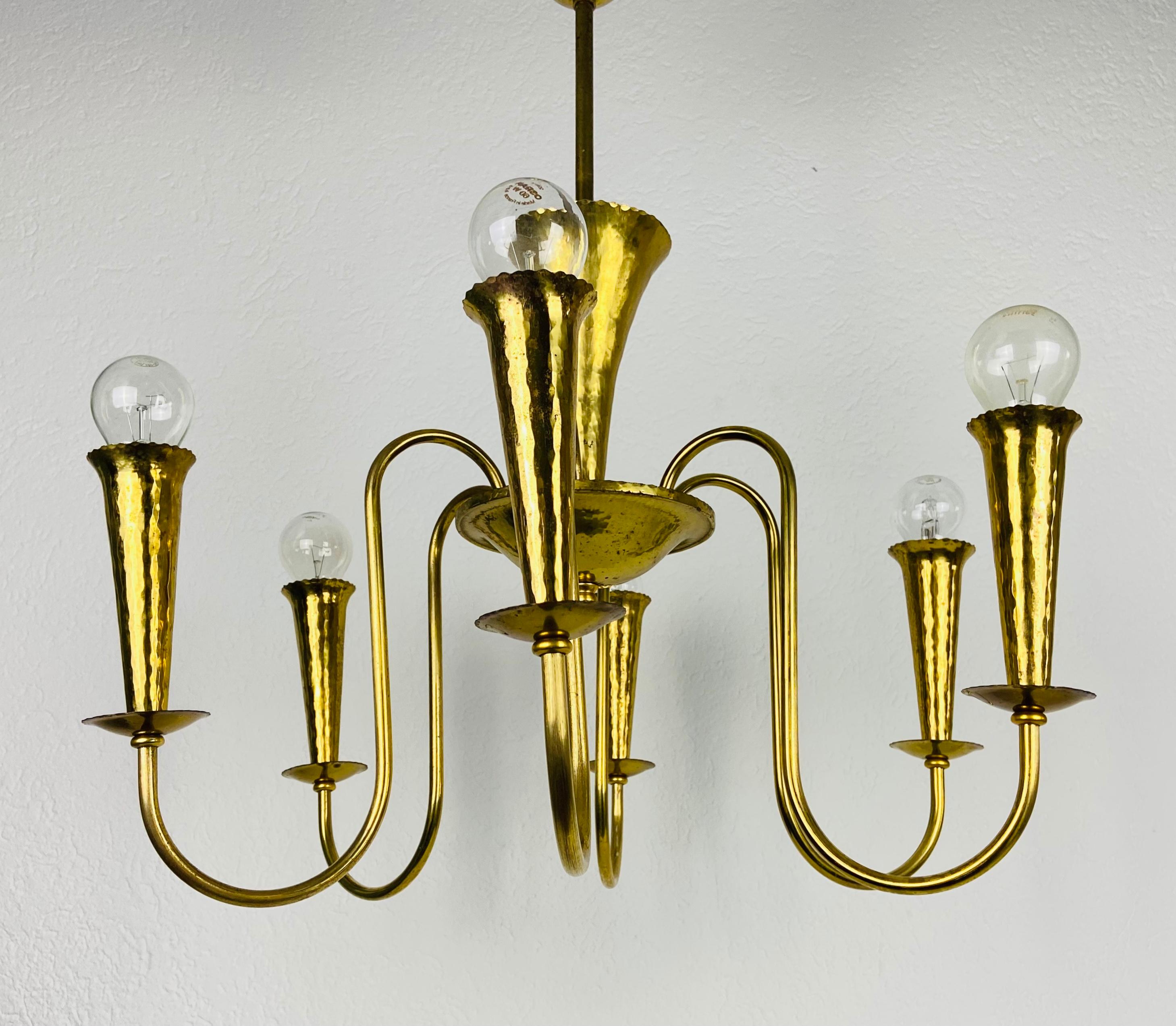 A Sputnik chandelier made in Italy in the 1950s. It is fascinating with its six brass arms, each of it with an E27 light bulb. The shape of the light is similar to a spider.

The light requires 6 E27 (US E26) light bulbs. Good vintage condition.