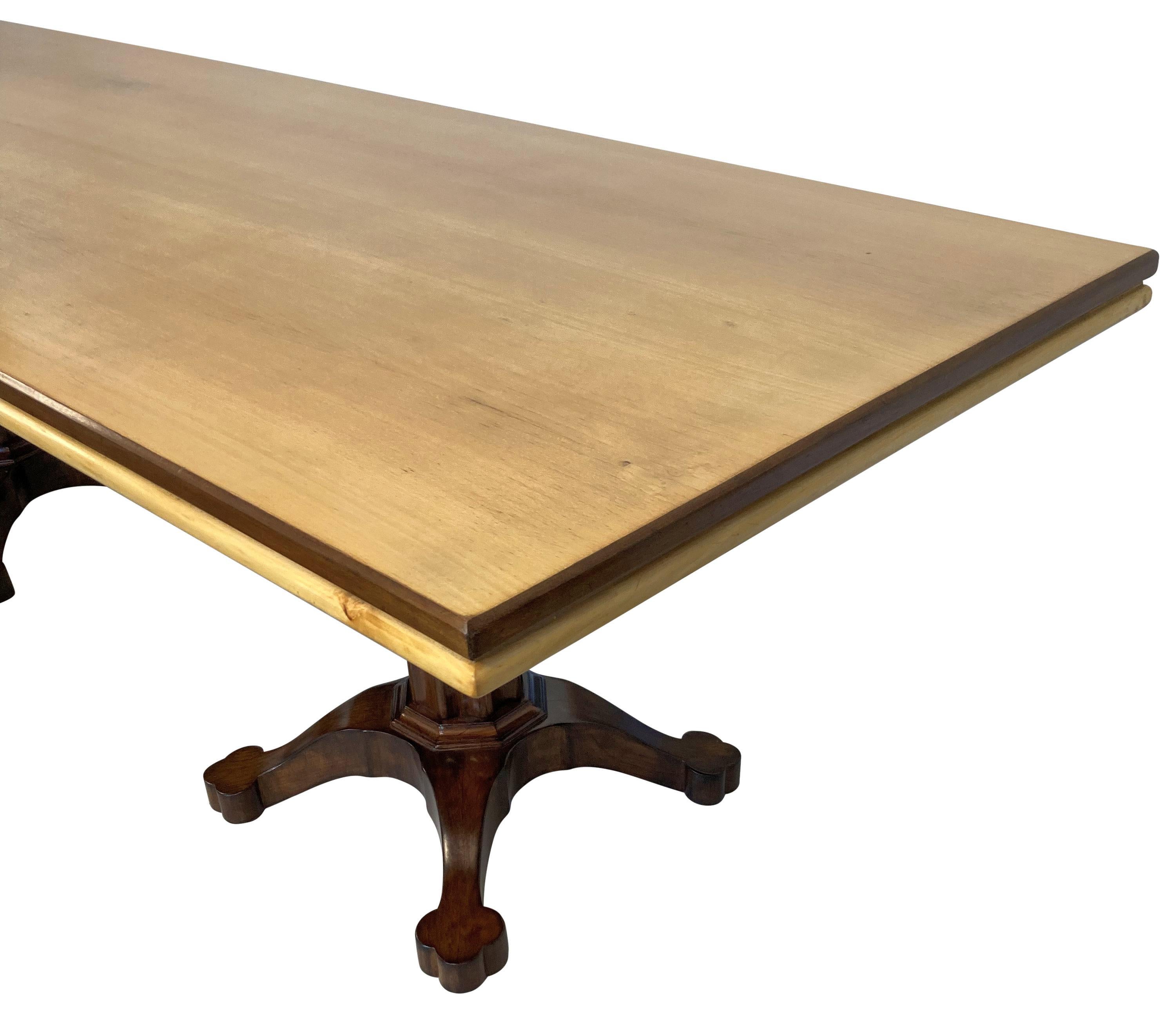 A large Italian Mid-Century dining table in walnut and lemon wood, with a twin pedestal base in the Gothic manner. This table will comfortably seat twelve people.