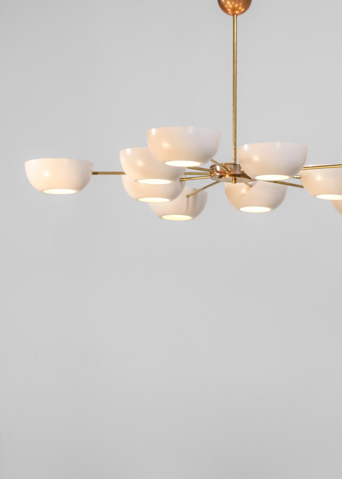 Beautiful modern chandelier in Gino Sarfatti style, structure in brass with metal lampshades and opaline glasses. 
Ten lights.
Finnish brass and color shades on request.
 