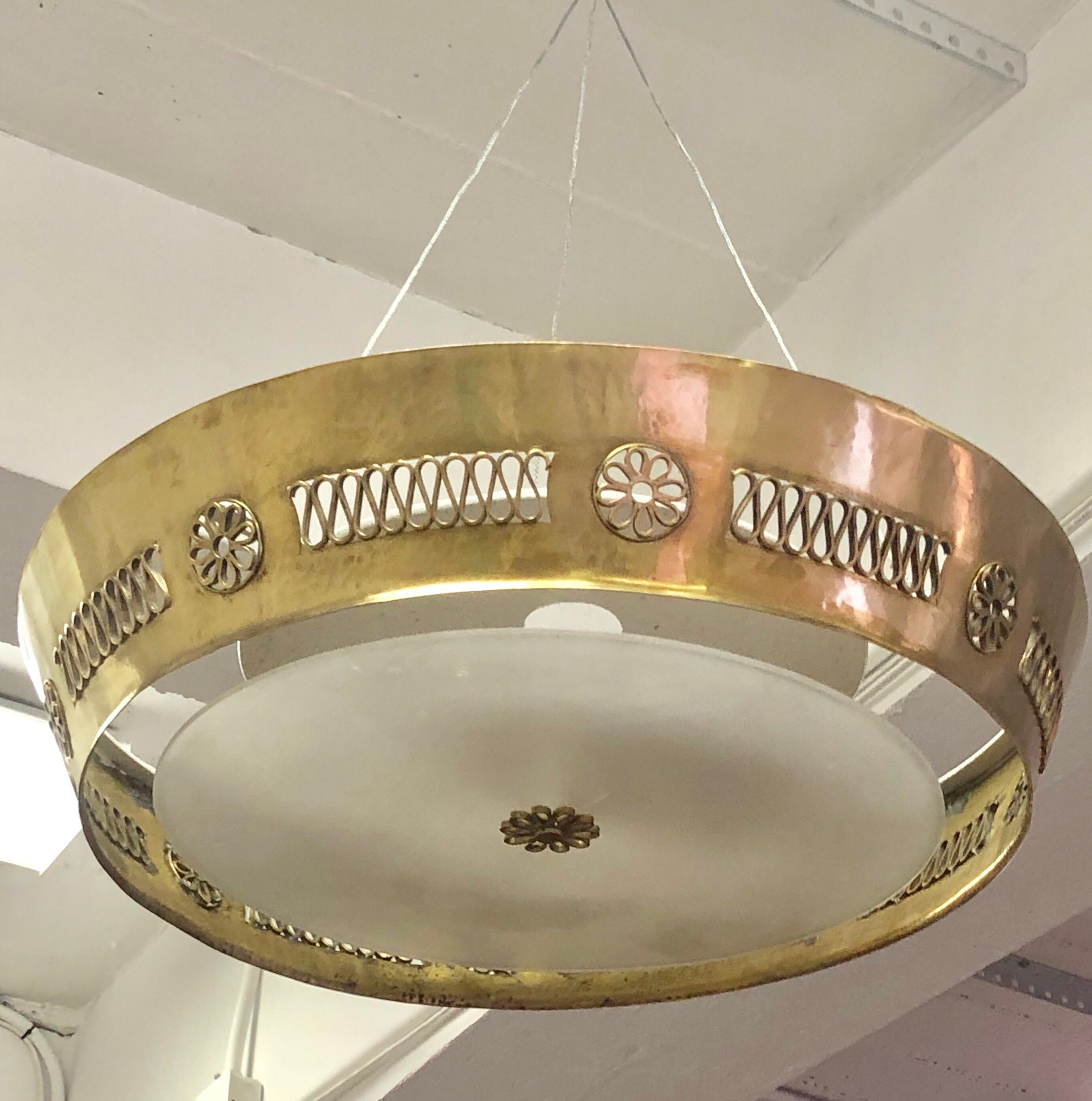 Large, elegant, Italian modern neoclassical, hand-hammered solid brass pendant or flush mount fixture attributed to Pietro Chiesa for Fontana Arte. 

This timeless piece is handmade with a round solid brass frame that has been delicately