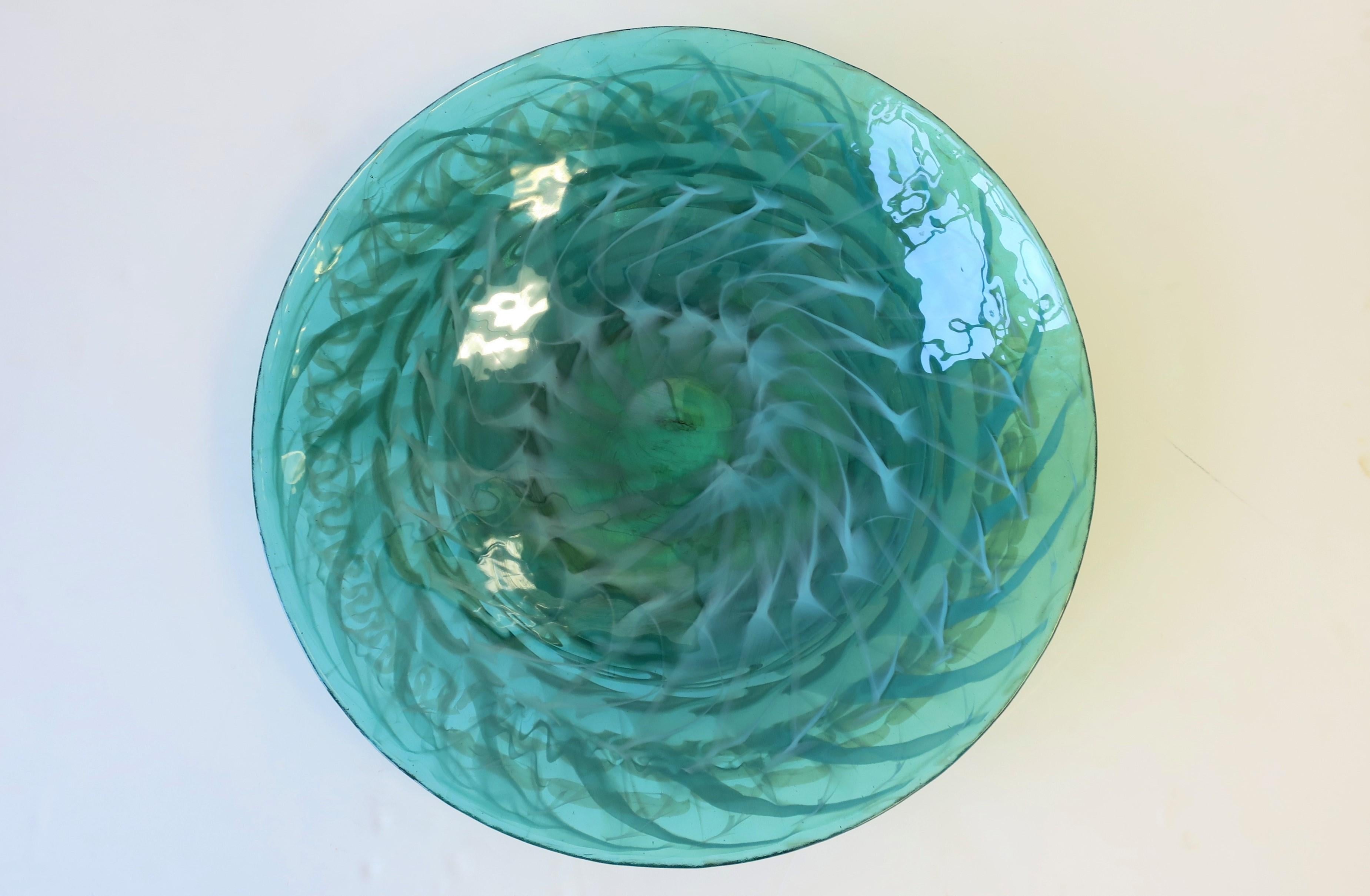 A very beautiful large round emerald green and white Italian Murano art glass centerpiece bowl. Bowl is predominantly emerald green with touches of white. A quarter placed next to bowl in image #3 to show scale. Marked on bottom as show in image #9.