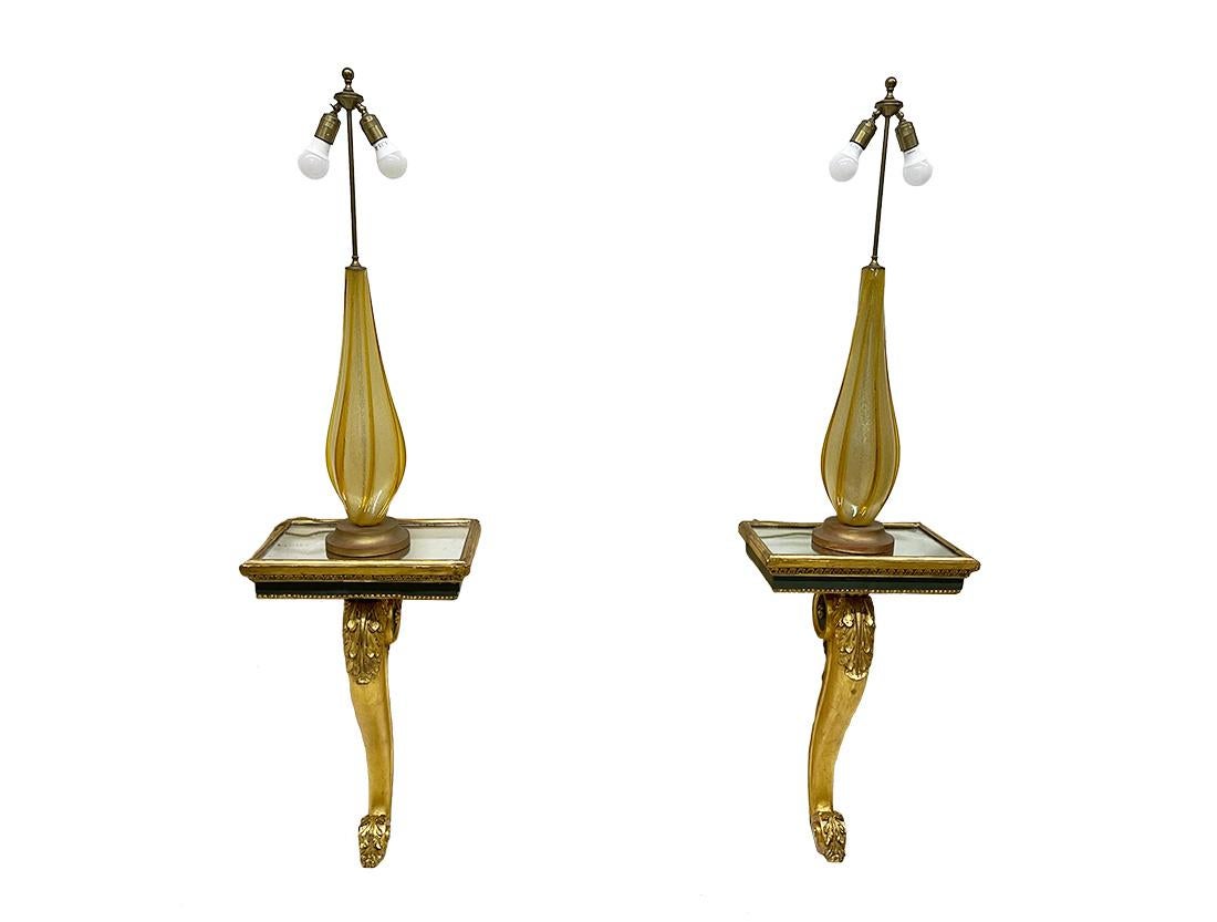Large Italian Murano glass table lamps, 1950s

Large Italian Murano glass table lamps made of slightly turned ribbed glass on a round wooden gilded base. The head consists of 2 fittings and these are adjustable. The electrical wire is still in its