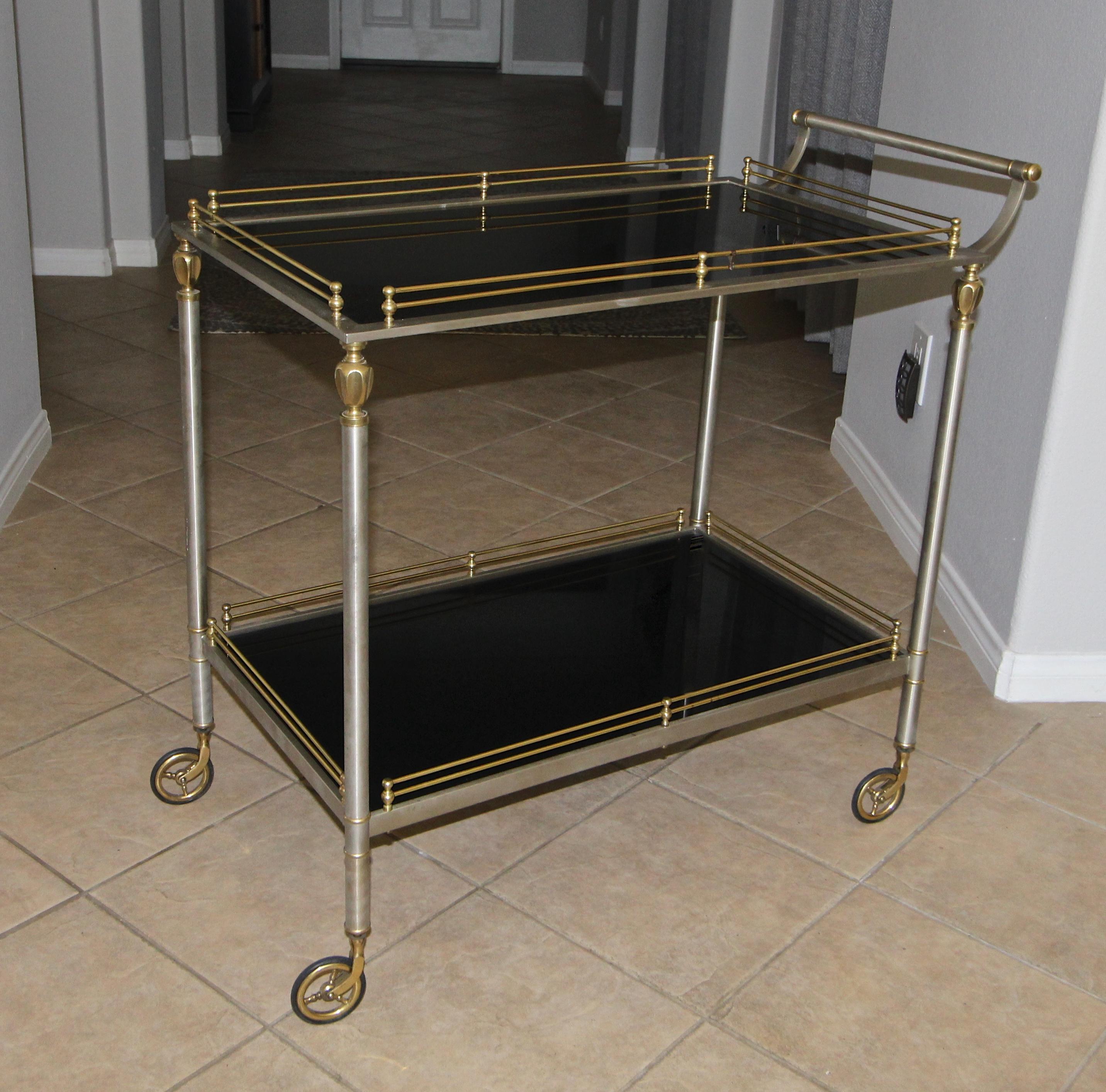 Larger scale brass and brushed steel Italian bar or tea cart, with two-tier black painted glass shelves. Nice detailing including gallery rail and round spoke caster wheels. Height to top of second self 30.5