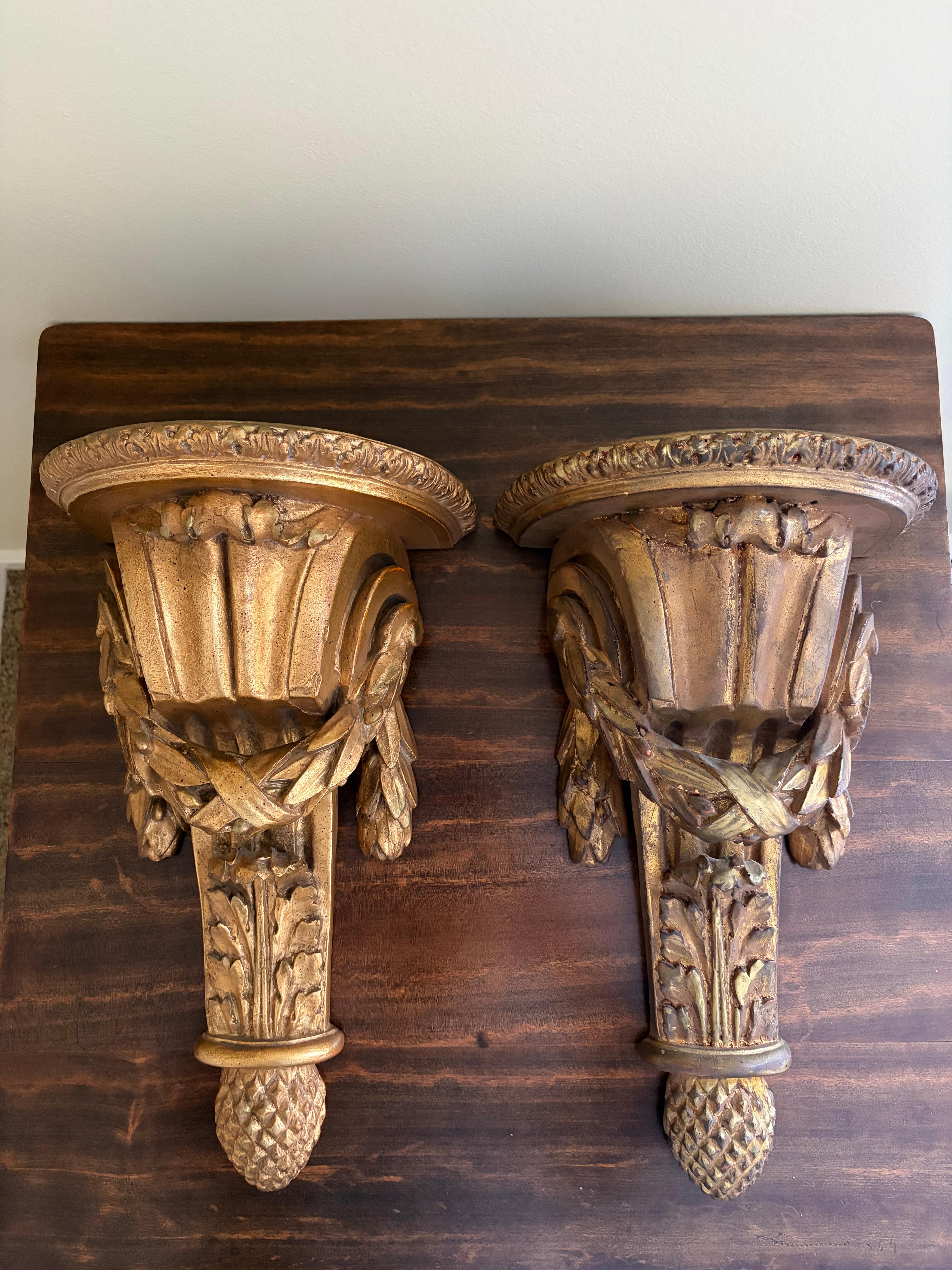 A gorgeous pair of large scale Neoclassical or Regency style gold gilt wall sconces, shelves, or brackets featuring stylized  foliate designs

By Borghese

Italy, Mid-20th century

Measures: 10.5