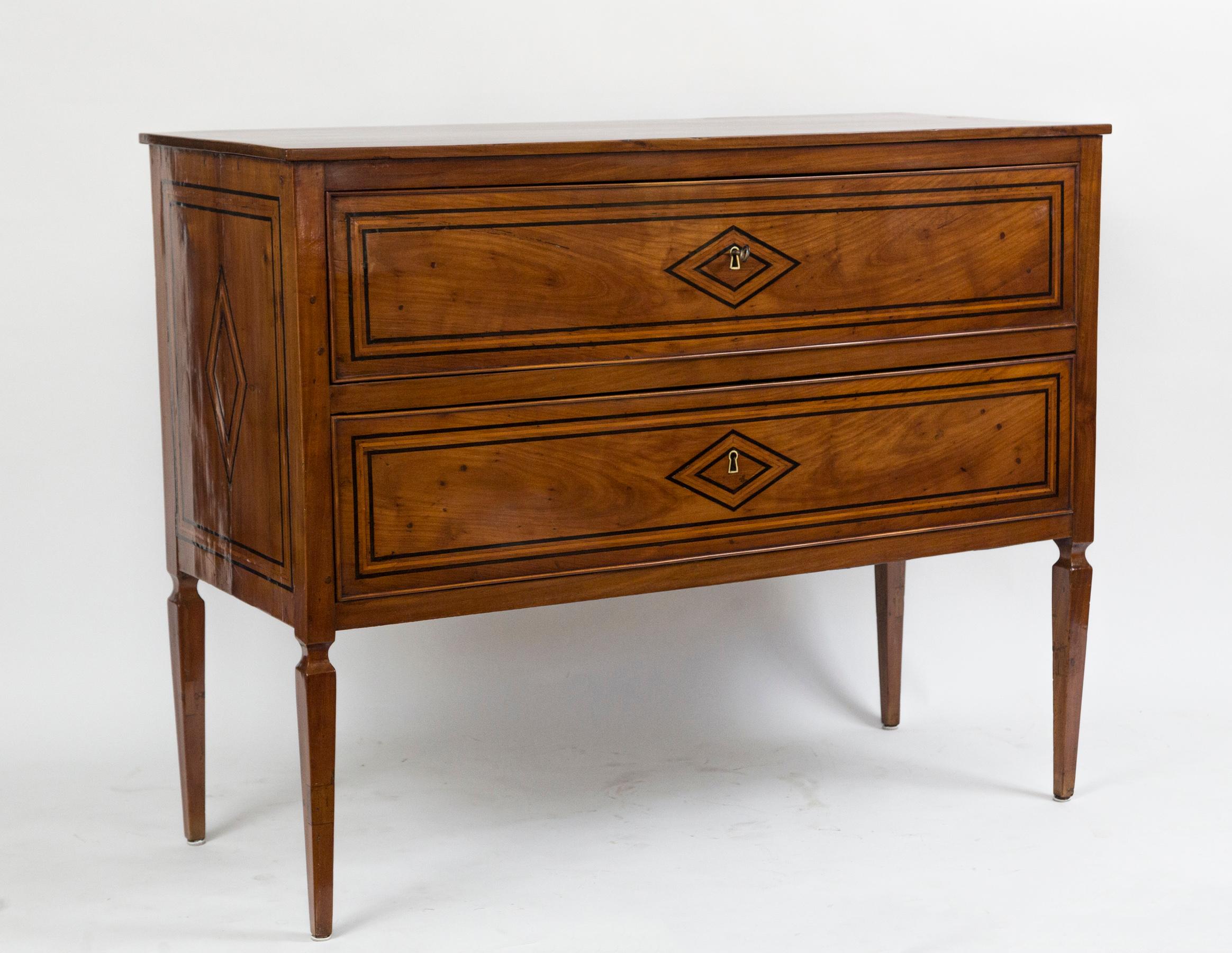 Handsome & tall dark fruitwood two-drawer chest finishing on high squared and tapered legs, adorned with geometric ebony & citron wood inlays
Origin: Southern Italy
Dating: 1880ca
Condition: Very good, recently restored and polished
Dimensions: