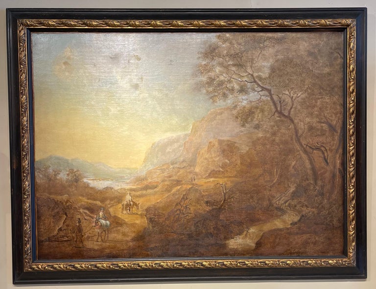 A large early 19th C. Italian Old Master style oil on canvas landscape painting depicting travelers along a road in a dramatic country setting mounted in later ebonized and gilt decorated frame.