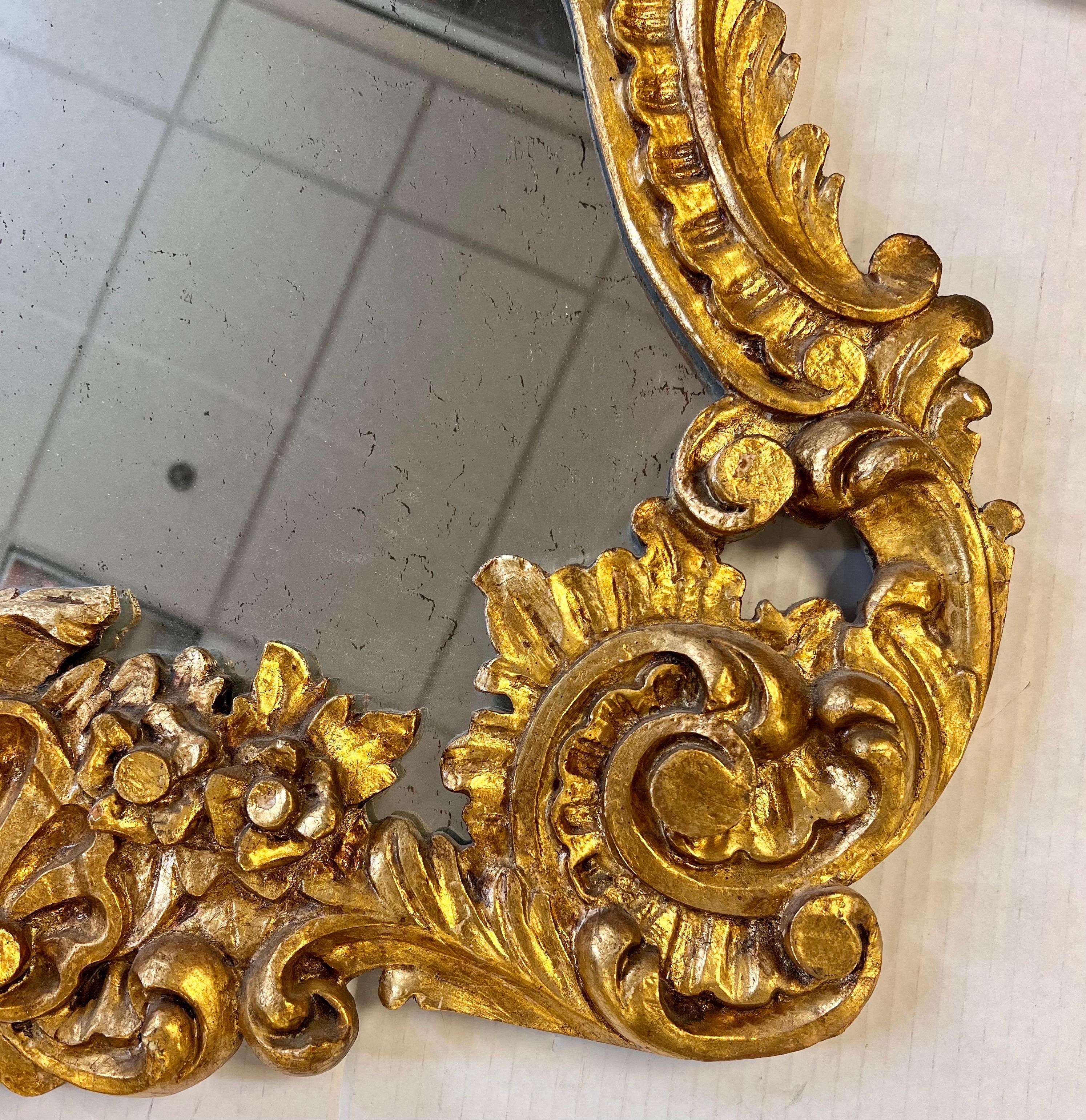 Stunning intricately carved giltwood mirror. Made in Italy.  Age appropriate wear and gorgeous.  Note we have the matching marble top demilune that matches this mirror also available this week on 1stDibs.