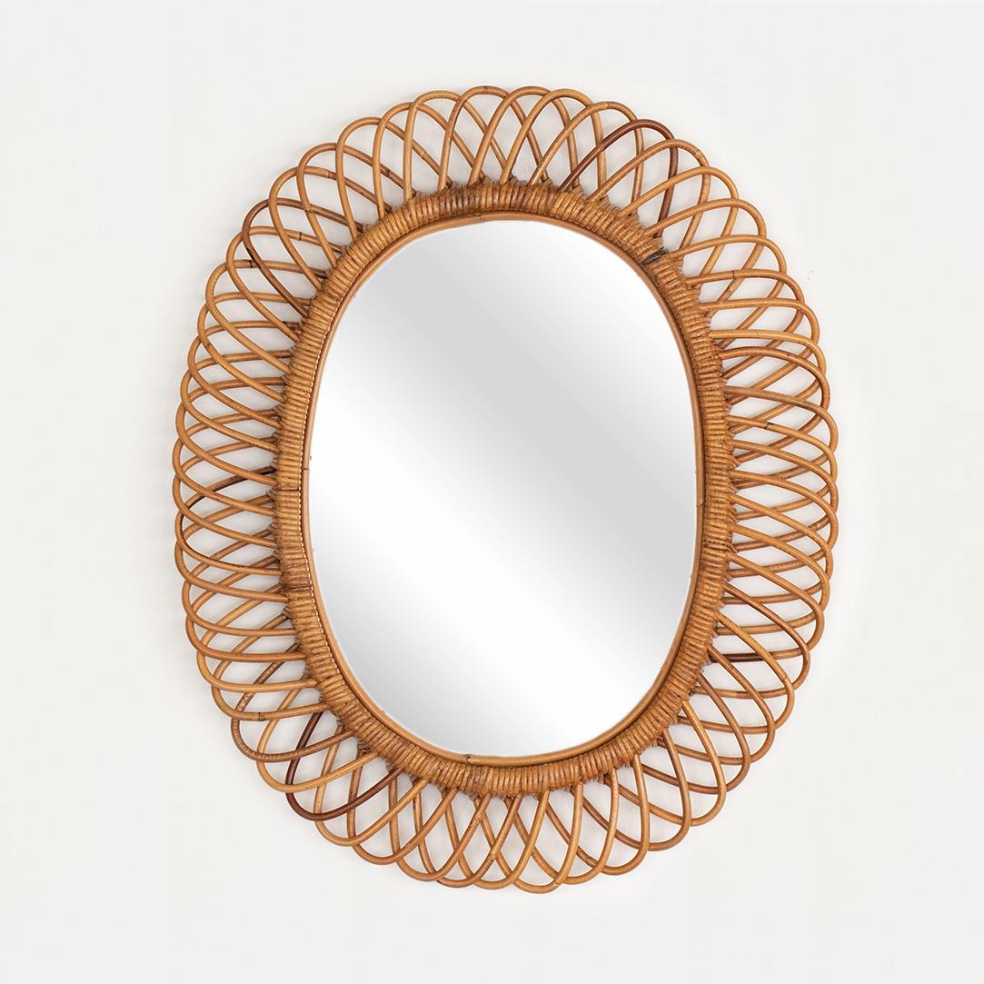Beautiful large oval rattan mirror in the style of Franco Albini from Italy, 1960's. Great size, perfect for bathroom or entryway. Nice vintage condition with original rattan frame and mirror.