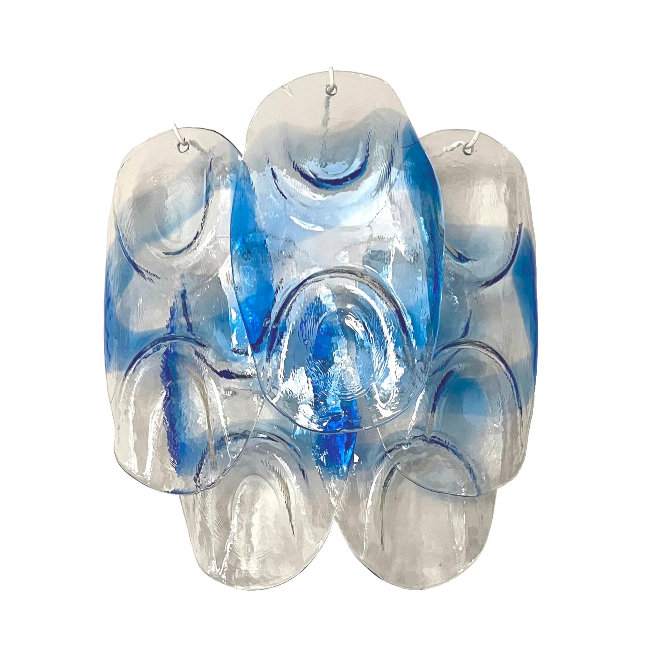 Marvelous, large and unique pair of Italian blue clear Murano glass wall sconces from 1970s.
These sconces were made during the 1970s in Italy for the Venice Company “Mazzega”.
Mazzega lie in the noble Venetian glassworking tradition; the firm was