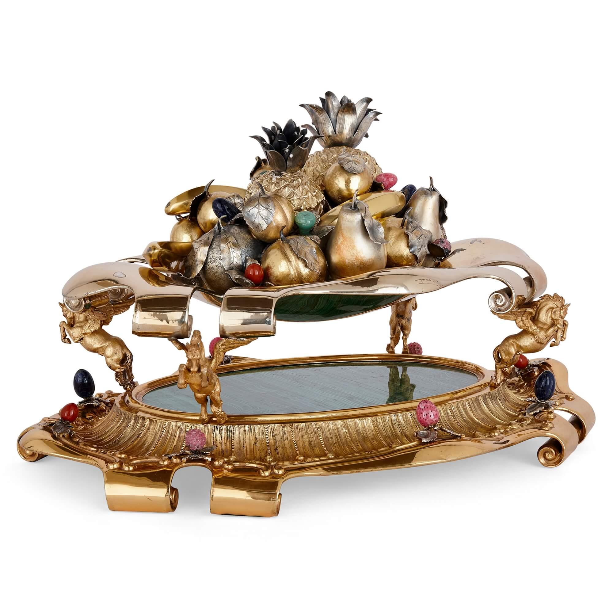 Large Italian parcel-gilt, silver, and hardstone centrepiece from Milan, c.1980
Italian, Late 20th Century
Weight: 14.064 kg
Height 40cm, width 69cm, depth 52cm

Bearing the mark of Argenteria Fiorentini & Spertini, of Milan, c.1980, this