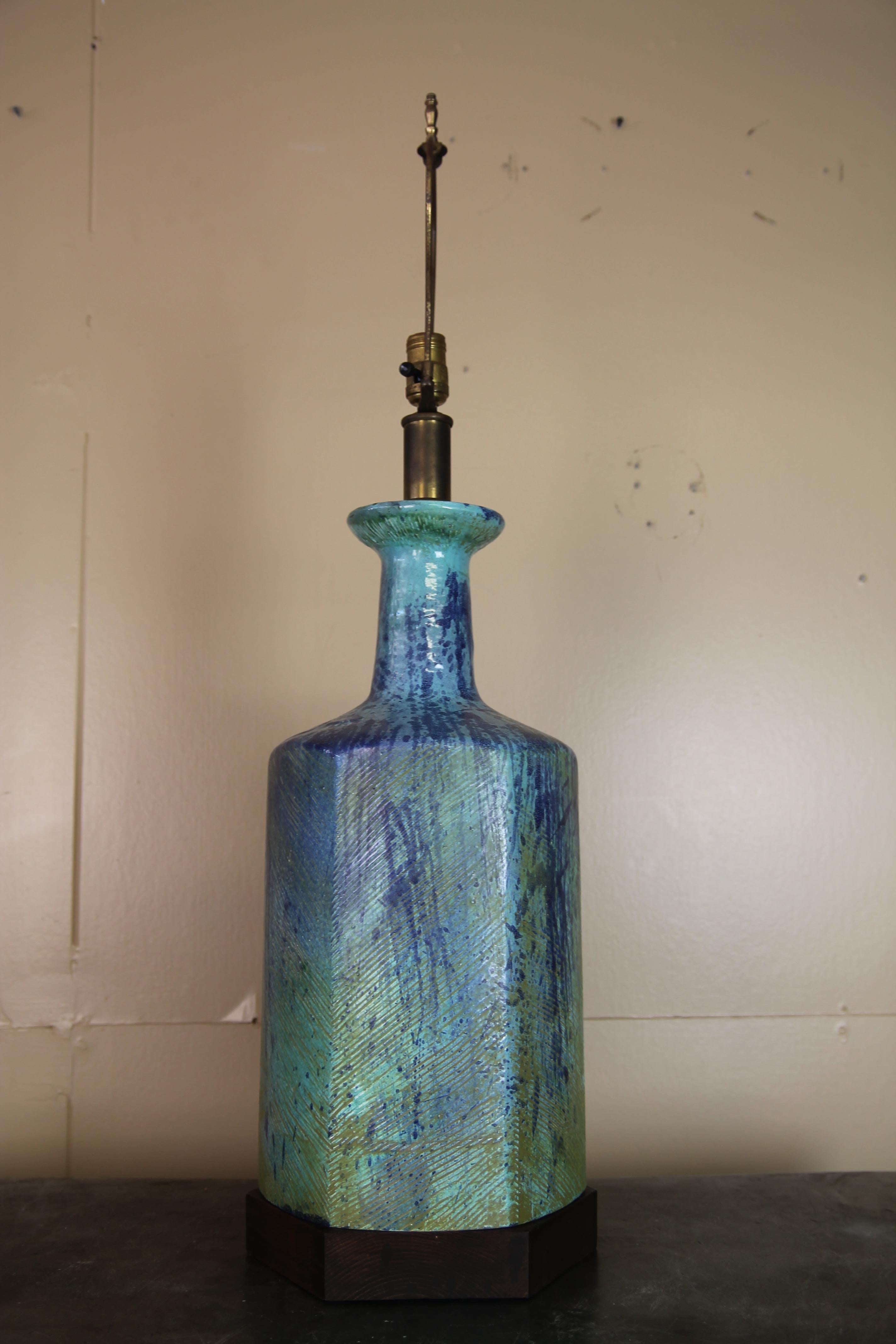 Large Italian pottery lamp with walnut base. Colors are great and  with the unique walnut base, this lamp makes a statement.