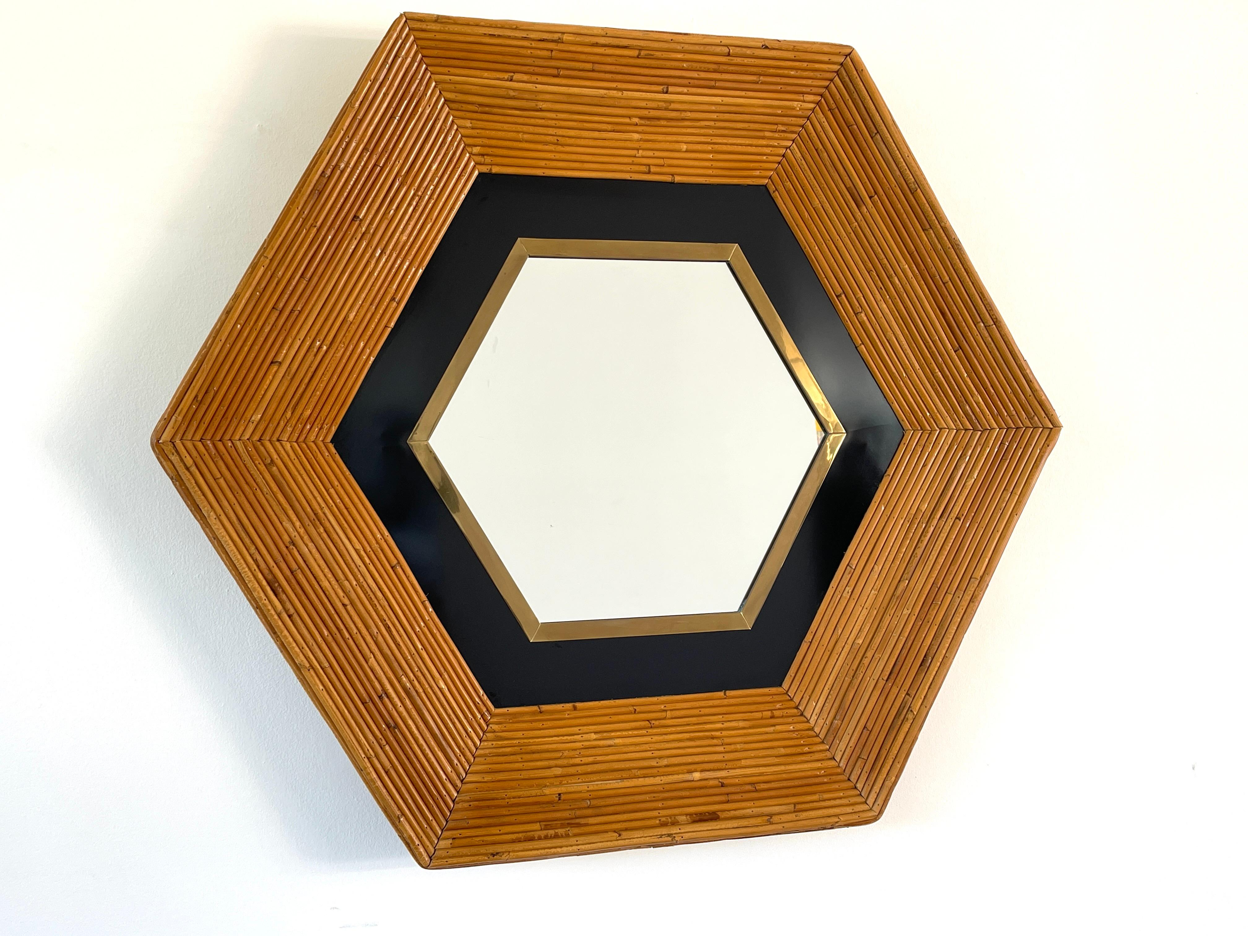 Impressive Italian designed mirror - circa 1970's 
Reed rattan with silvered mirror, brass and black metal detailing on the hexagon shaped frame. 
Wood backed.
Extremely well made.