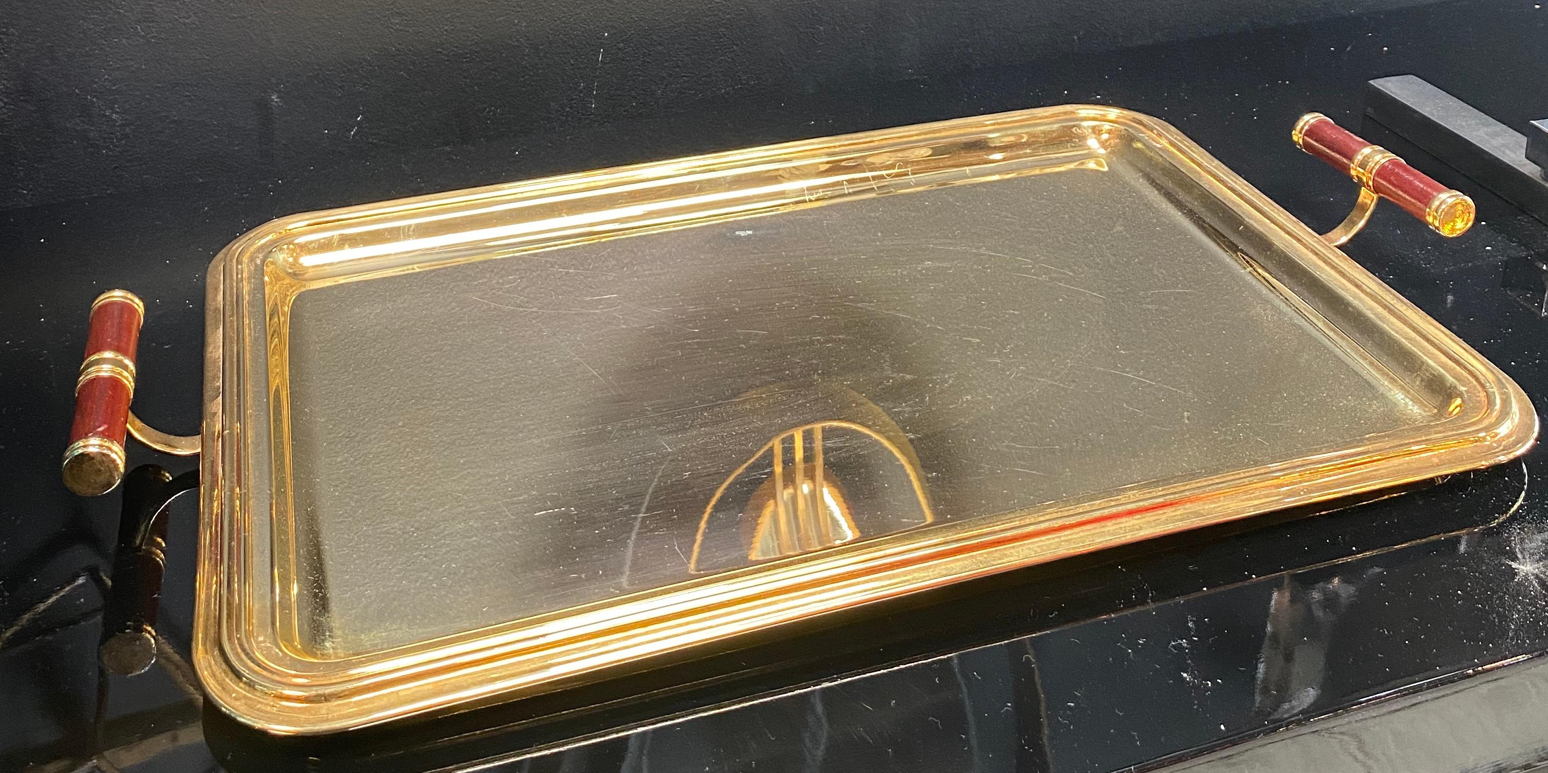 Large and beautiful 24-karat gold-plated tray with two beautiful wooden handles, the tray was produced in Italy in the 1970s in vintage condition the tray has some scratches but the beauty is truly unique and ready to give a touch to your
