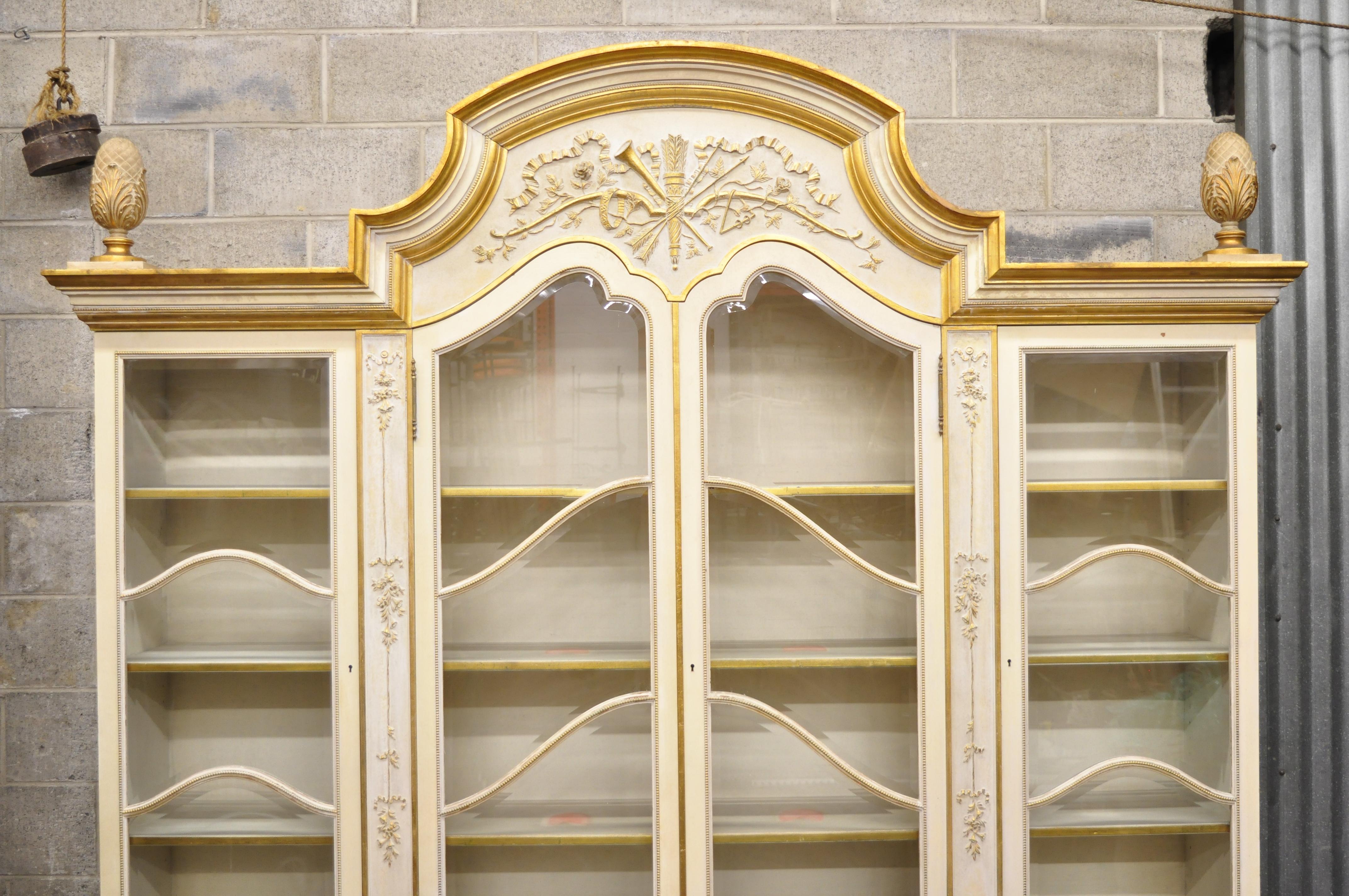 Large Italian Regency cream and gold gilt breakfront China display cabinet



Details: 2 piece construction, cream and gold gilt distressed finish, beveled glass doors, 12 adjustable wooden shelves, working lock and key, carved musical