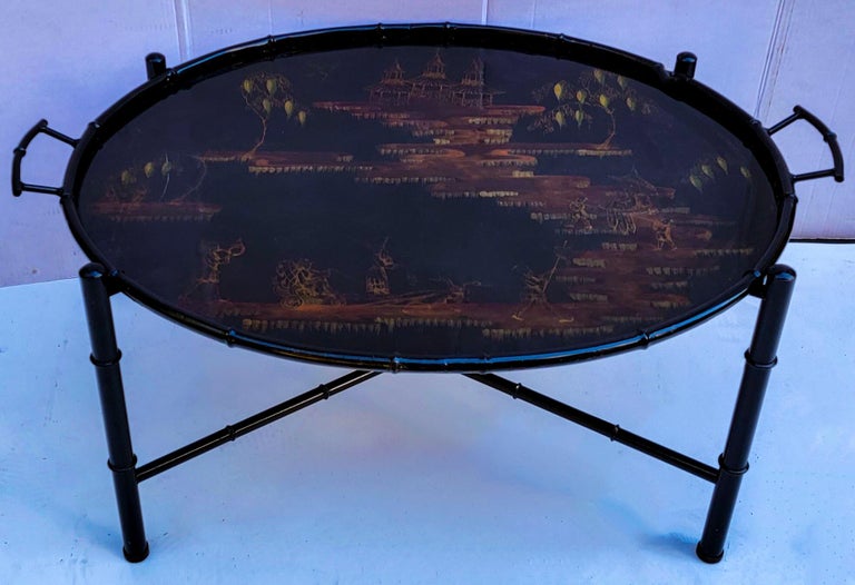 This is a large scale Italian Regency style faux bamboo chinoiserie tole tray table. The tray is removable and marked with the “Made in Italy” sticker. The tray and frame are metal. The piece is in very good condition.