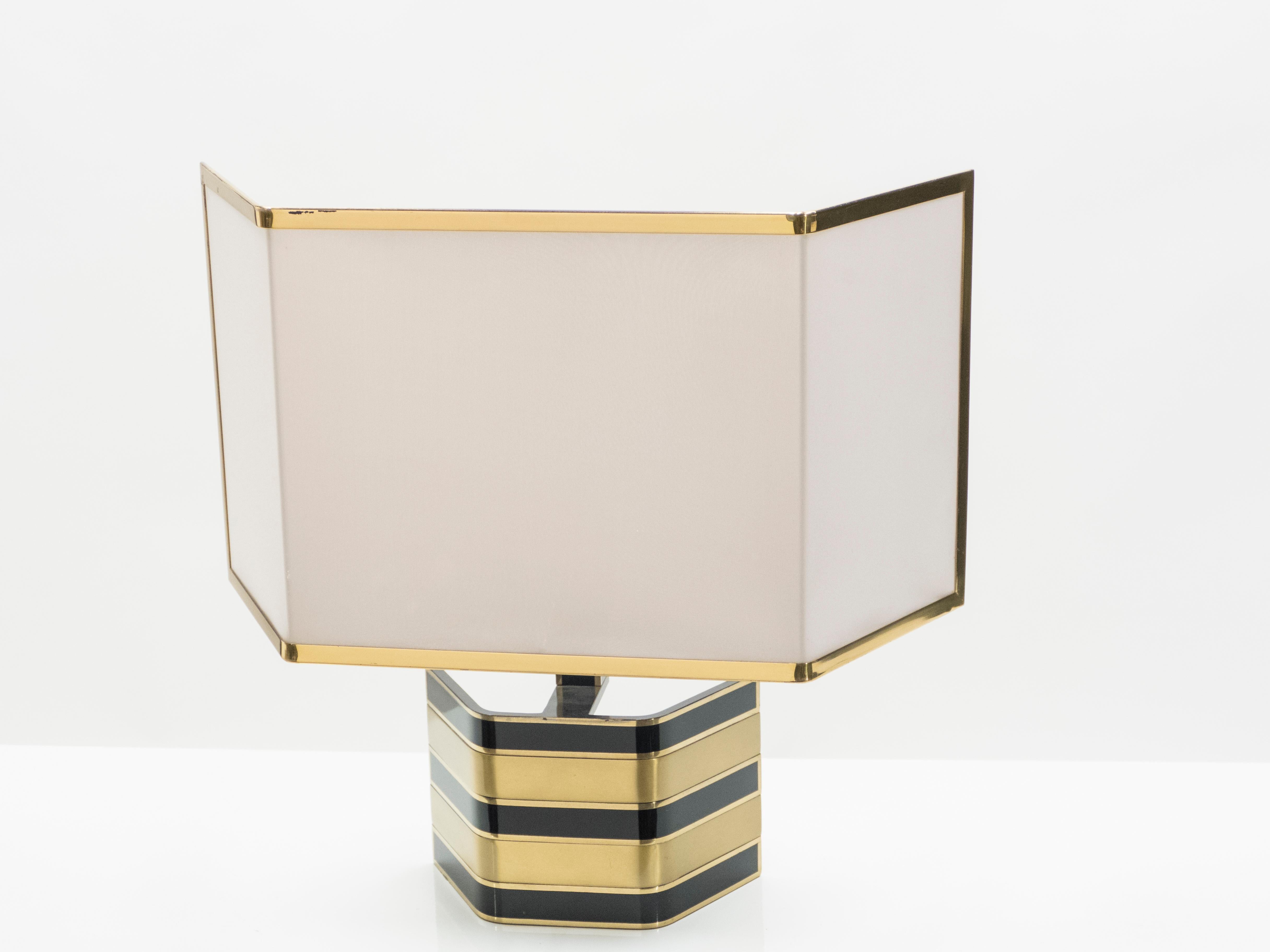 This rare lamp possesses the unique allure that is held by unconventional, decorative designs, most notably those by Italian metal designer Romeo Rega. Cool brass and sleek black lacquer form a combination that is immediately arresting and chic. The