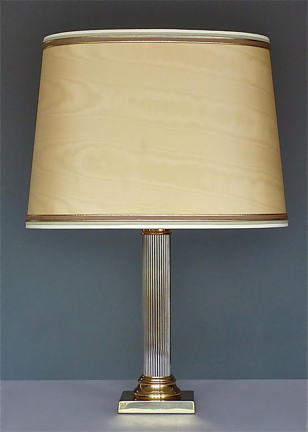 Large Italian Romeo Rega style column table lamp made of gilt brass in combination with chrome, Italy, circa 1970-1980. The beautiful table lamp which exudes a warm and pleasant light is 64 cm / 25.20 inches tall including original oval lamp shade