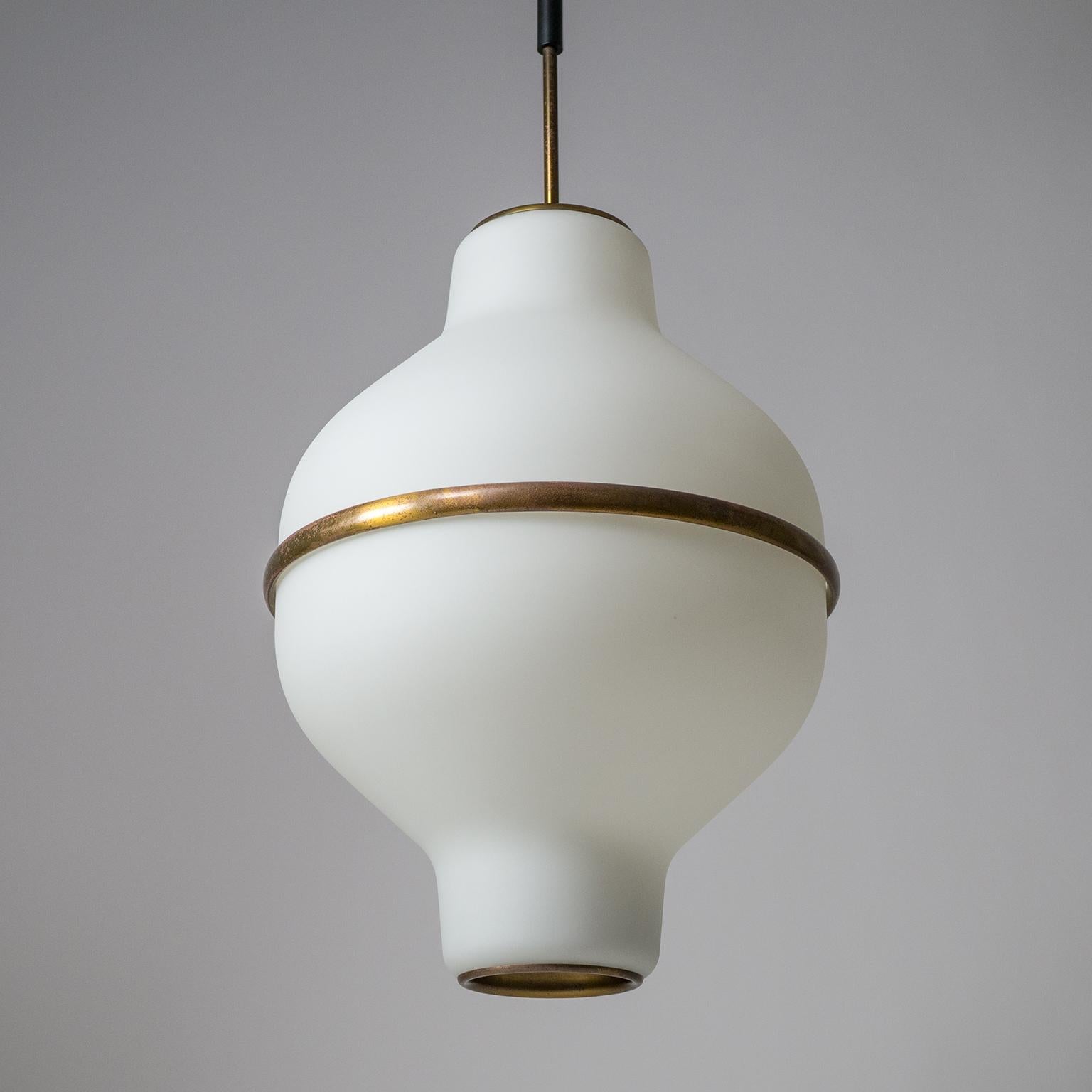 Superb Italian satin glass chandelier from the 1950s, designed by Oscar Torlasco for Lumi Milano (original manufacturers label on top). Two large tapered blown glass diffusers with a satin finish and a thick brass 