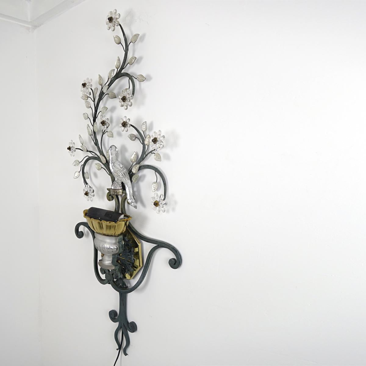Impressively large Italian sconce with a crystal bird, flowers and leaves. 
The internal bulb provides for a warm up-light.
      