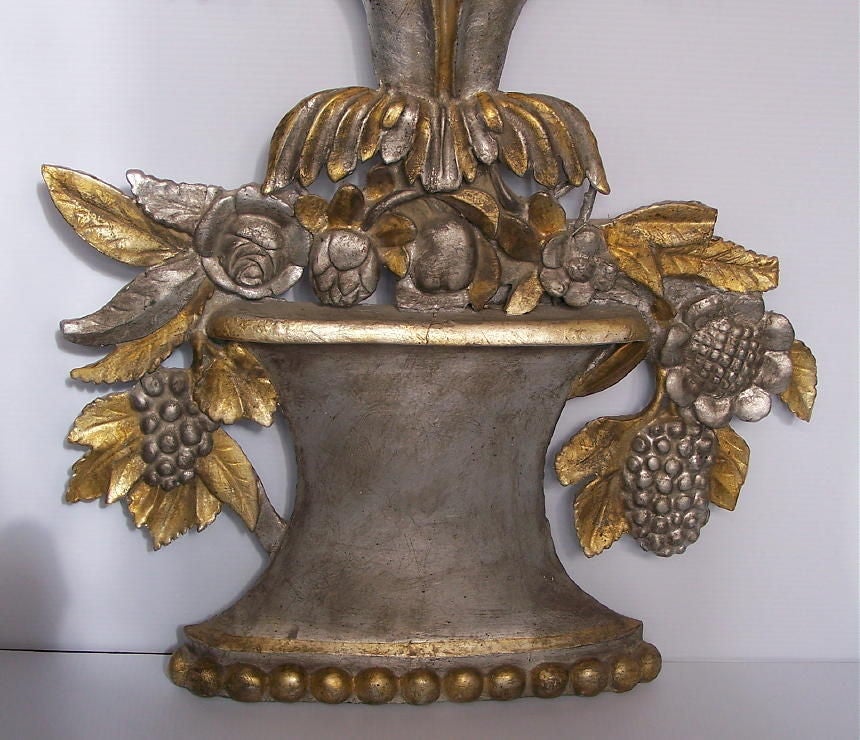 A large hand carved wood basket of fruit decorative element with silver and gold gilt.
Early 19th century, possibly 18th century.
The paint is older but not original.