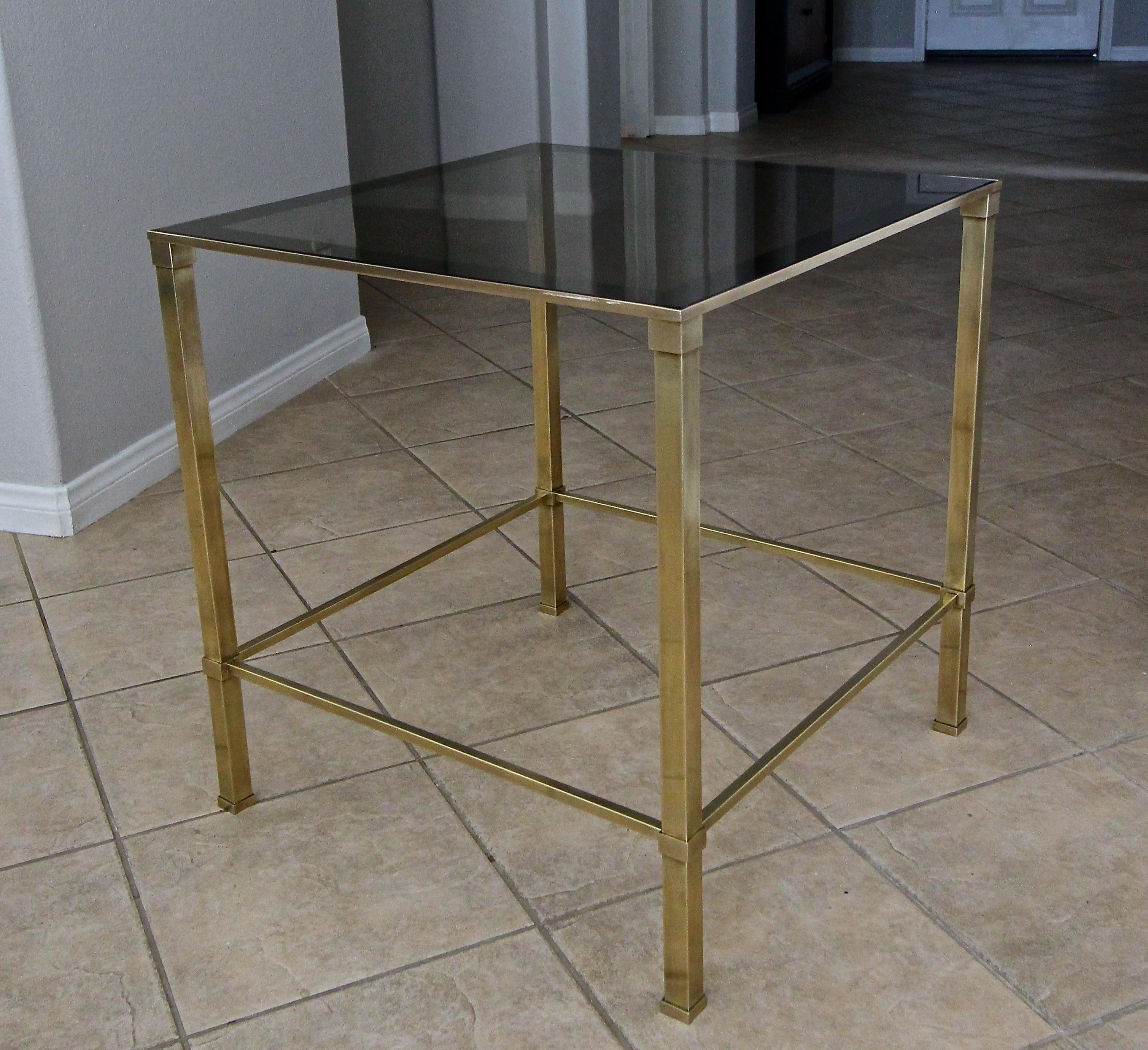Large scale brass 2-tier square side or occasional end table, with tinted glass mirrored edge insert top. Nice overall aged patina to brass. Quality constructed with solid brass framing. Attributed to Mastercraft.