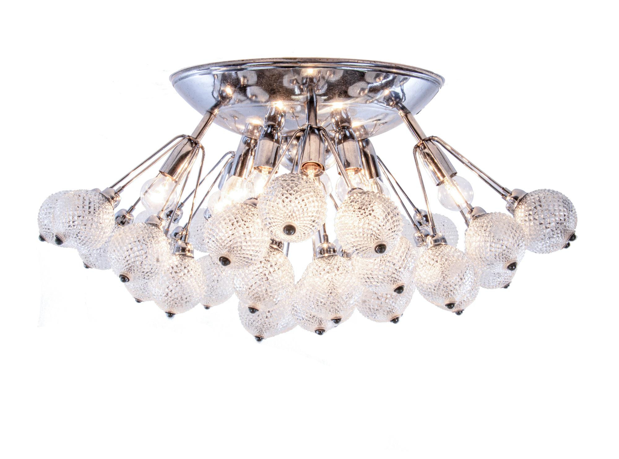 Elegant large starburst crystal glass and chrome flush mount chandelier made in Italy in the 1960s. The chandelier has a modernist look and thanks to strong illumination it offers a beautiful play of light. Chandelier illuminates beautifully and