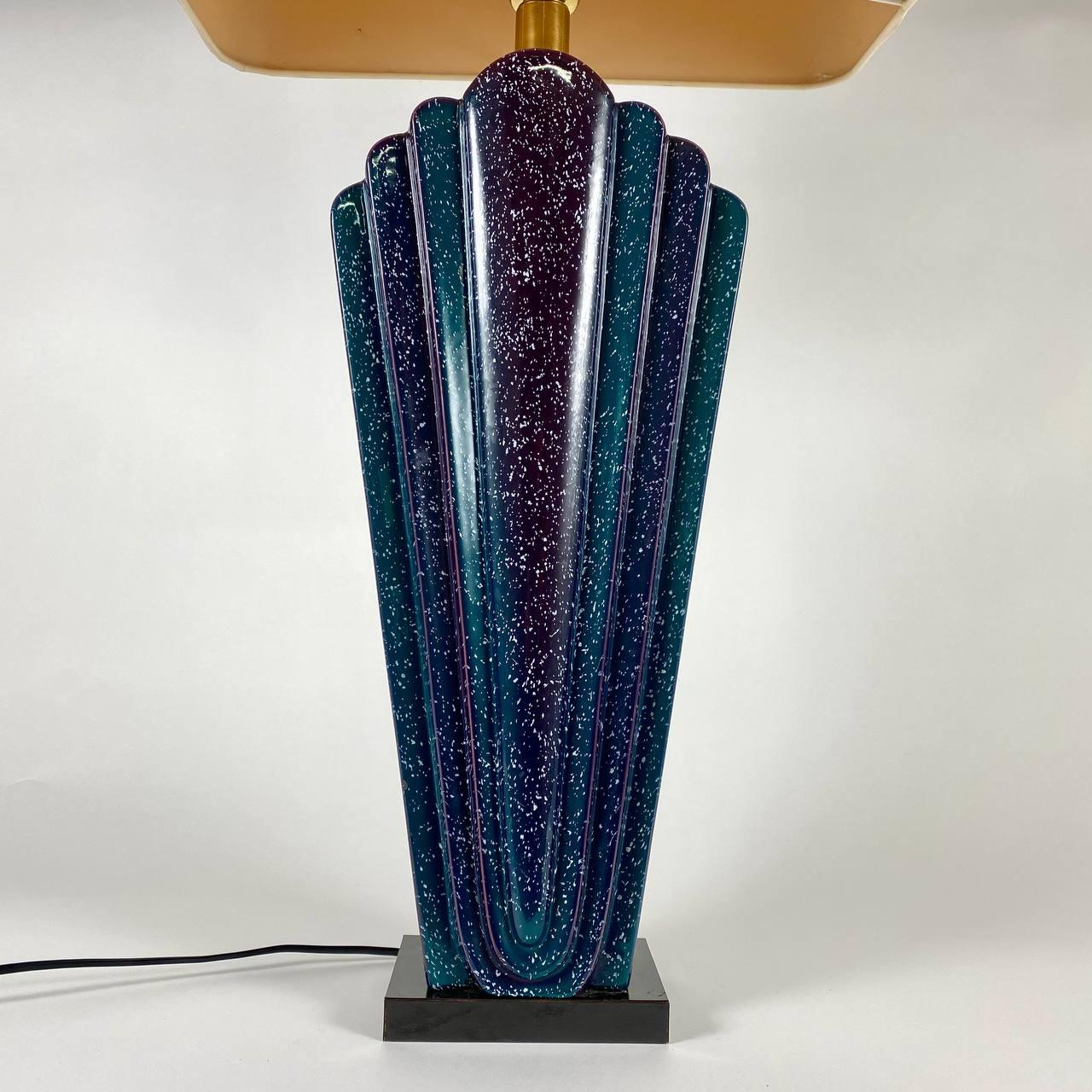 Large vintage table lamp from the Italian manufacturer showcases minimalist forms and a well-defined silhouette. 

It is mounted on a black pedestal. The base is made of Murano glass in rich shades of aquamarine, violet and blue which will add a
