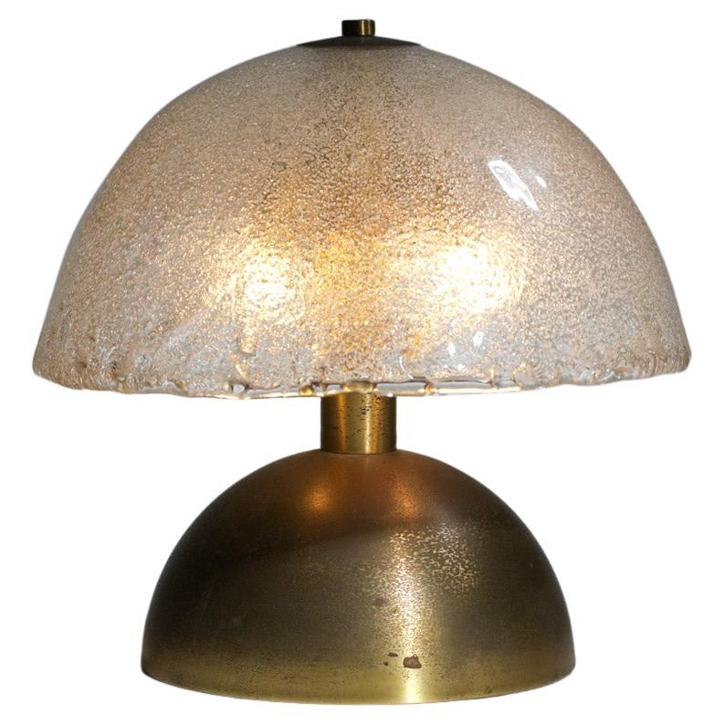 Italian table lamp of the 60s attributed to the designer Angelo Brotto. Half sphere shade in thick Murano glass and structure of the base and the lamp in solid brass. Very nice vintage condition with a nice patina of time on the brass (see picture).