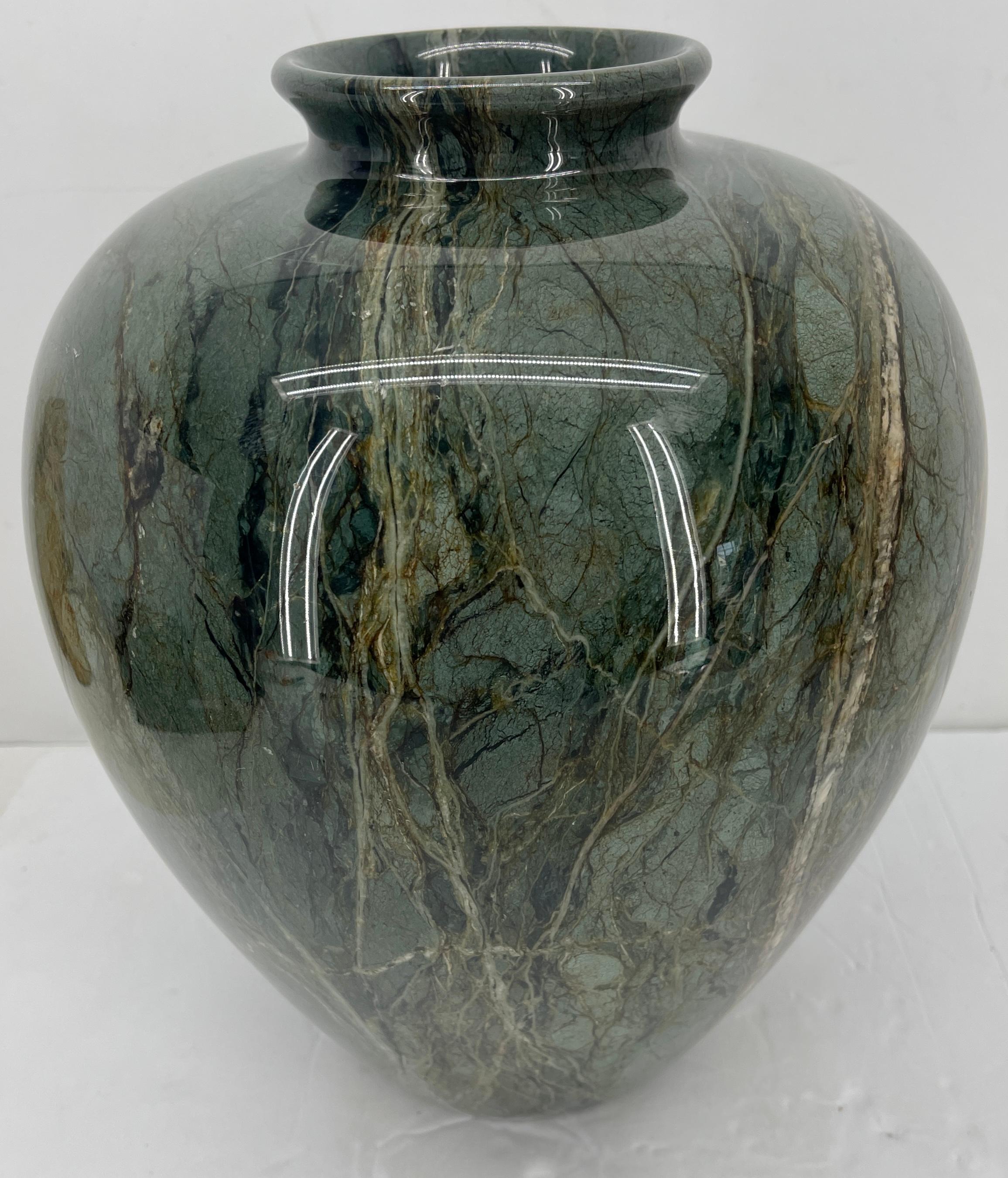 Large Mid-Century Modern European green marble vase or urn. Circa 1960's, this magnificent tear drop shaped marble vase is time and elegant in any decor. The vase is perfect as a desk accessory, center table piece or bookshelf decor. Fully
