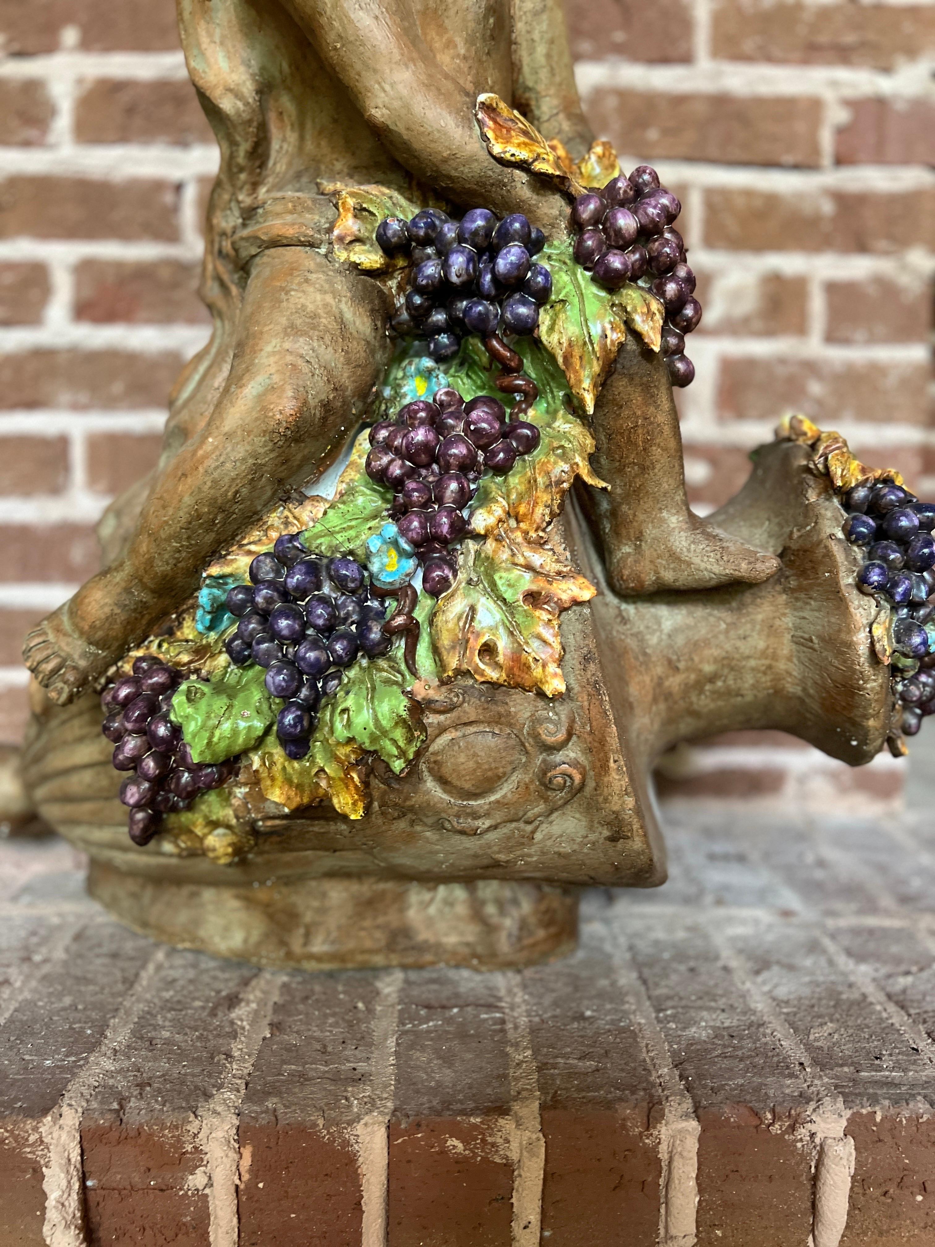Italian, mid 20th century.

Large Italian Terracotta Putti & Grape Vine Adorning a Wine Vessel Sculpture

Presenting a captivating masterpiece of Italian artistry, this Large Terracotta Sculpture adorned with Paint Decorated Putti stands as a