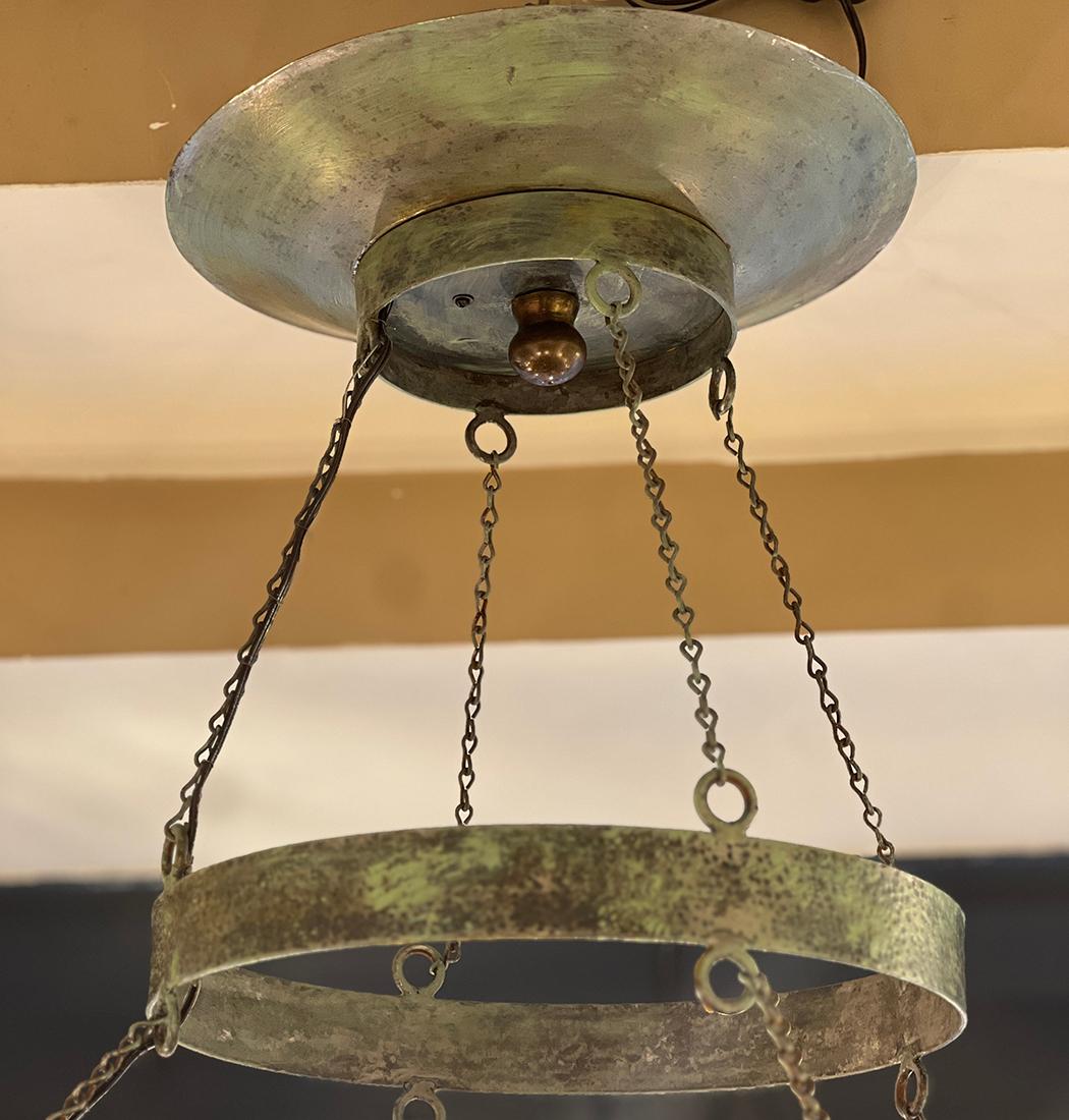 A large circa 1950's patinated tole chandelier with 12 lights. Openwork cup holders depicting birds.

Measurements:
Drop: 52