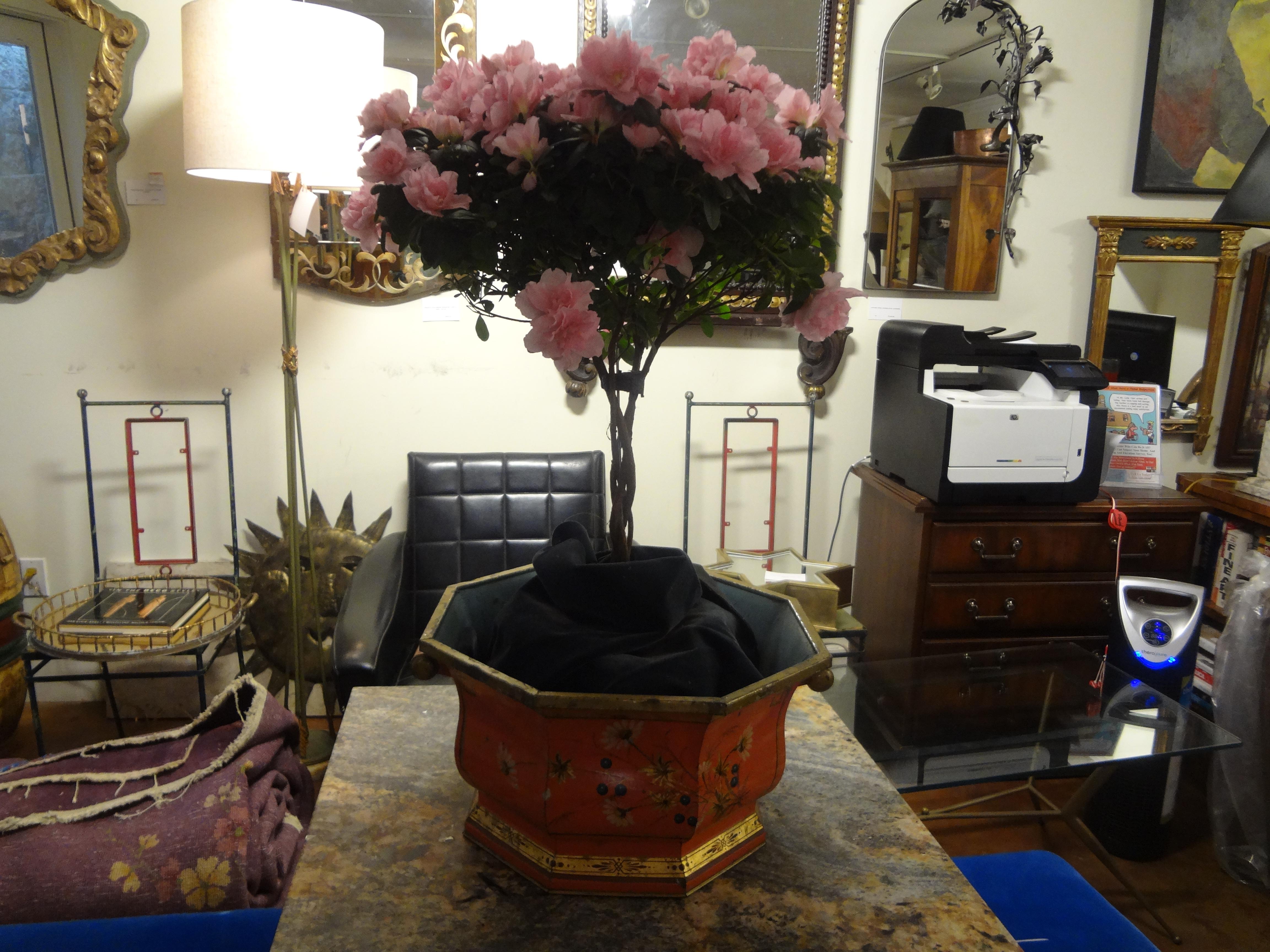 Massive Italian octagonal tole painted and gilt decorated jardinière. Urn or cachepot with handles. This stunning Italian chinoiserie jardinière or planter is a gorgeous shade of coral trimmed in gilt and hand decorated with wildflowers. This