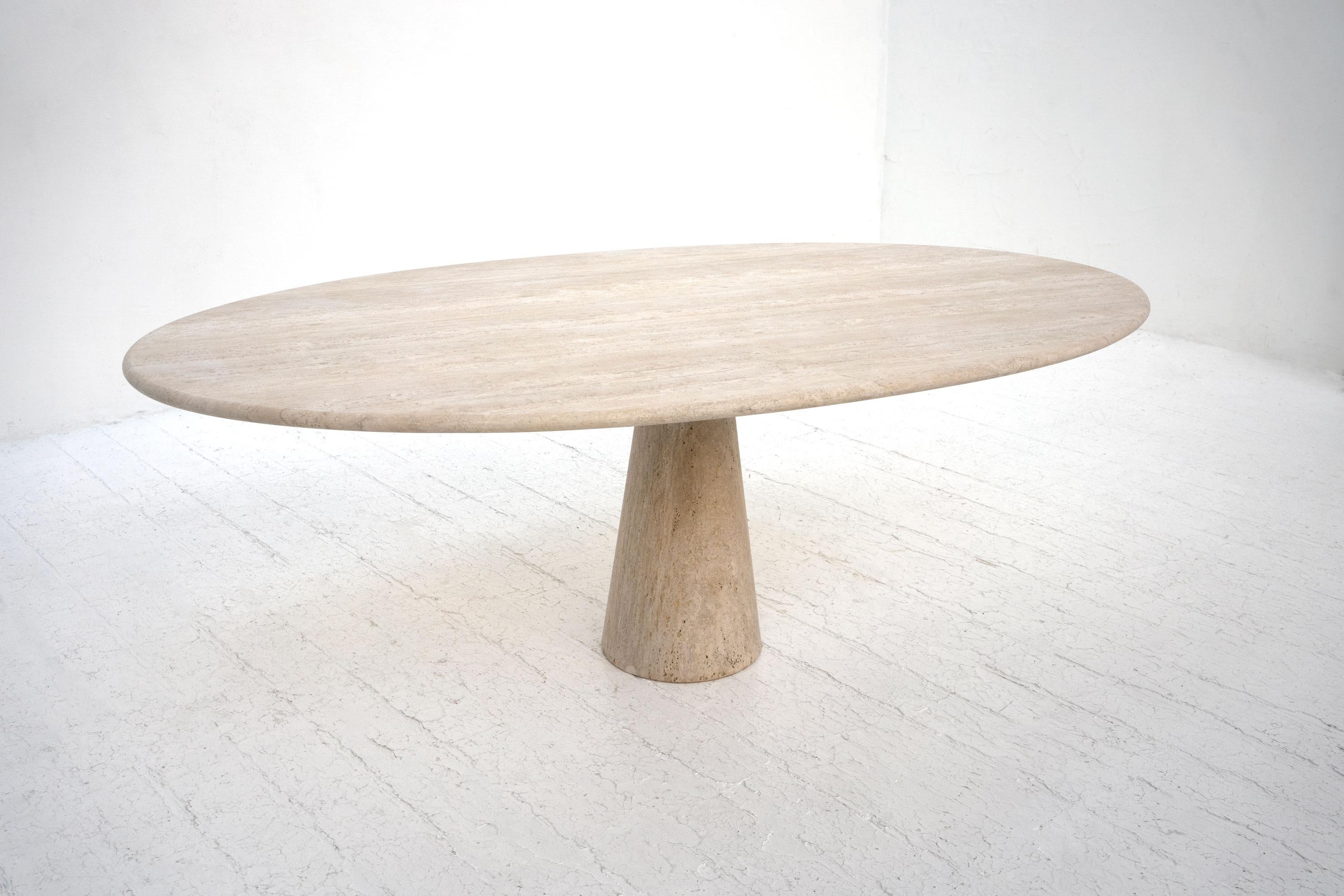 A large travertine dining table manufactured in Italy, c.1970. Composed from a solid travertine conical base supporting an oval travertine top. 

Seats 6 - 8

Dimensions (cm, approx):
Height: 73
Width: 120
Depth: 195
