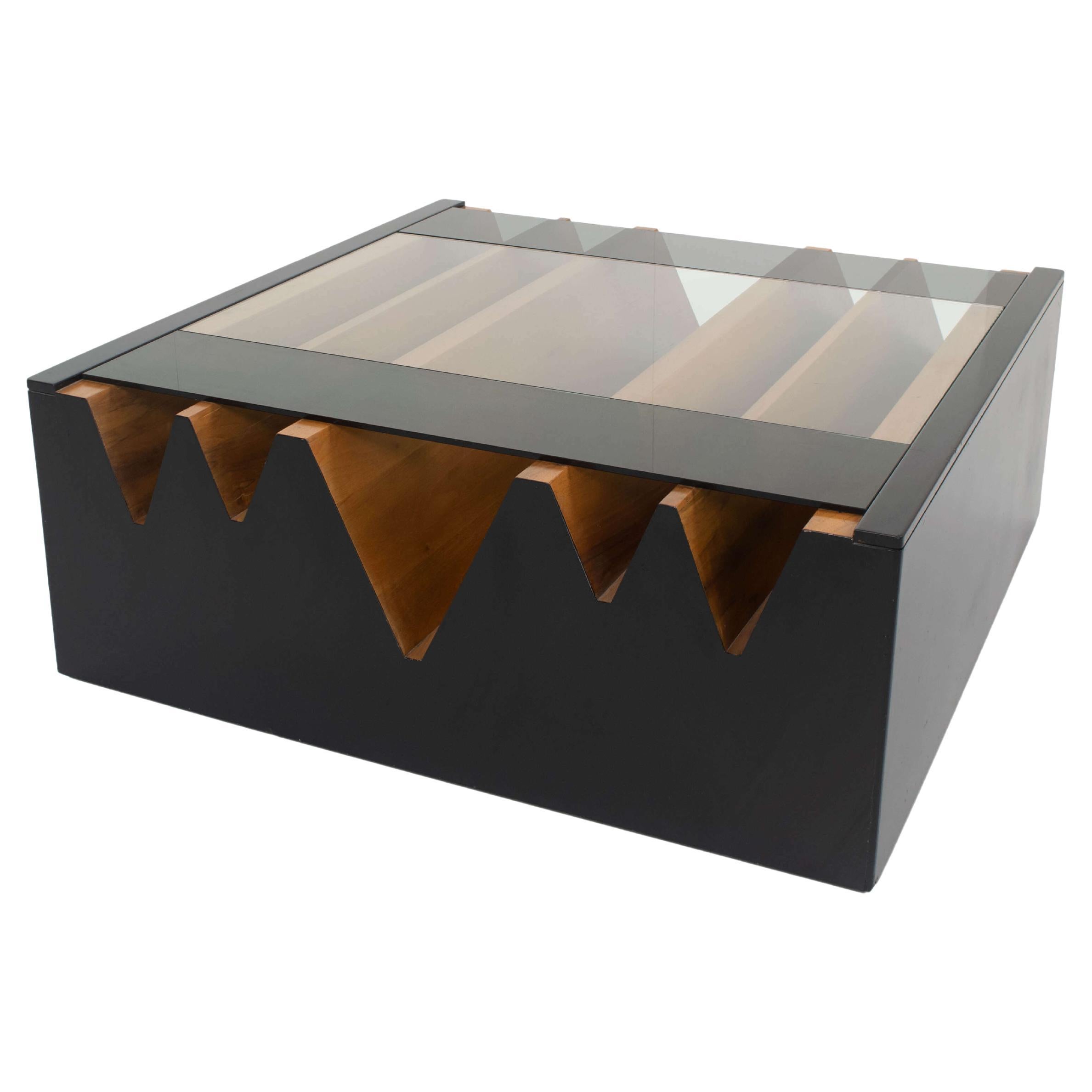 Impressive large Italian vintage coffee table attributed to Saporiti, ca the 1970s. This coffee table has a black lacquered base with a wood-coloured 'landscape-like' inside. The top consists of one piece of glass covering half of the top, leaving